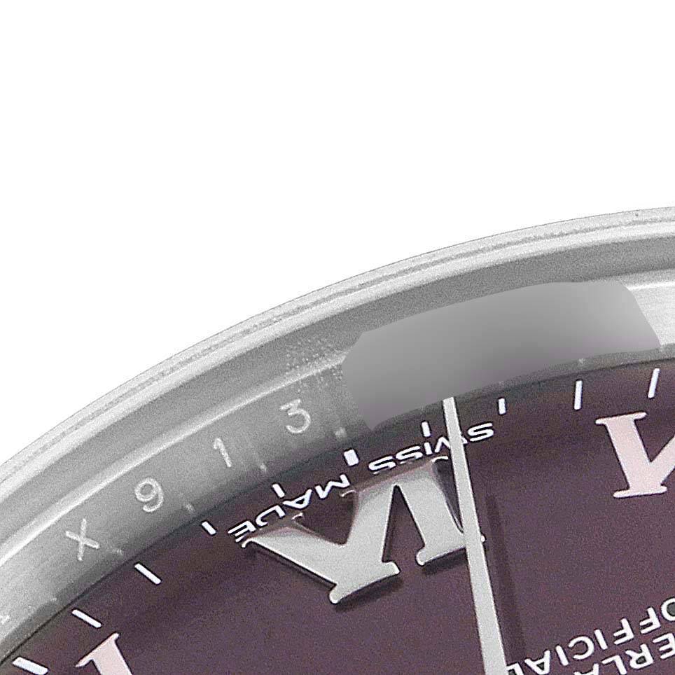 This close-up image shows the dial and part of the case edge of a Mid-Size Rolex watch.