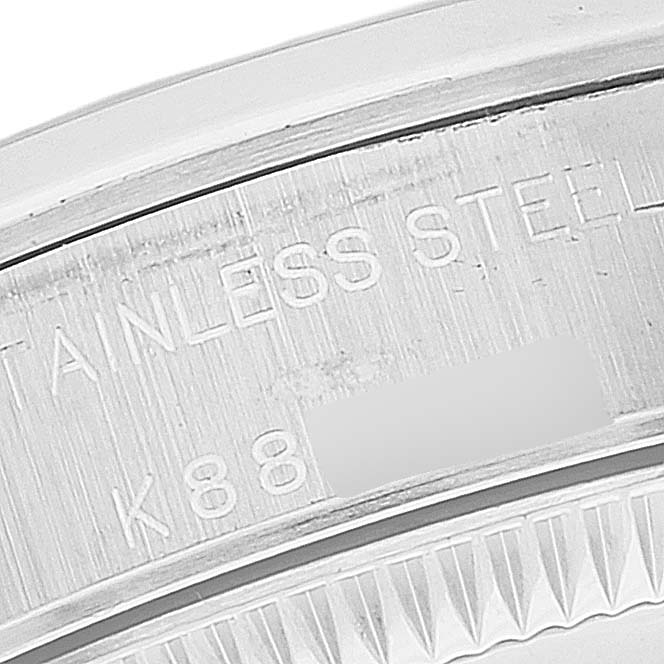 This image shows an angled close-up of the stainless steel engraved bezel of a Rolex Oyster Perpetual 76080 Women
s Stainless Steel Pink Dial 76080 Women
s Stainless Steel Pink Dial watch.