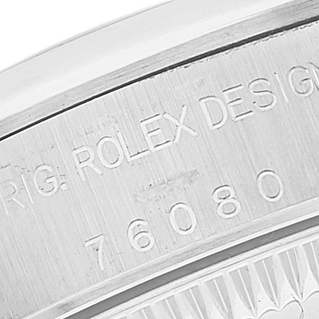 It shows a close-up of the case back of the Rolex Oyster Perpetual 76080 Women
s Stainless Steel Pink Dial 76080 Women
s Stainless Steel Pink Dial watch, highlighting the engraved text and serial number.