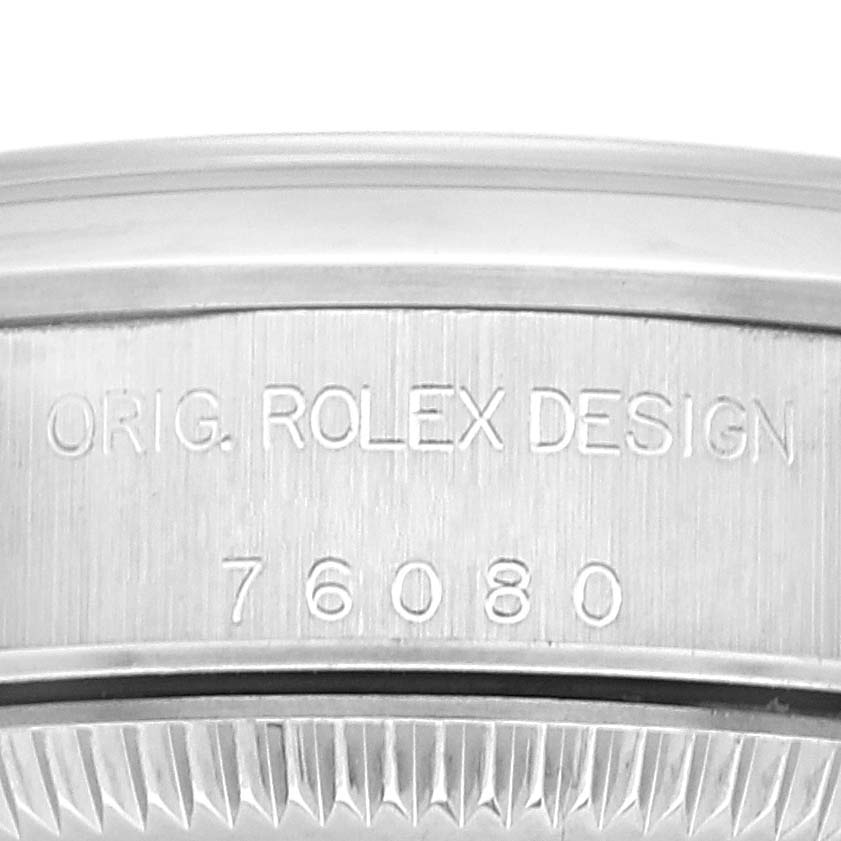The image shows the inscription and reference number on the case back of a Rolex Oyster Perpetual 76080 Women
s Stainless Steel Pink Dial 76080 Women
s Stainless Steel Pink Dial watch.