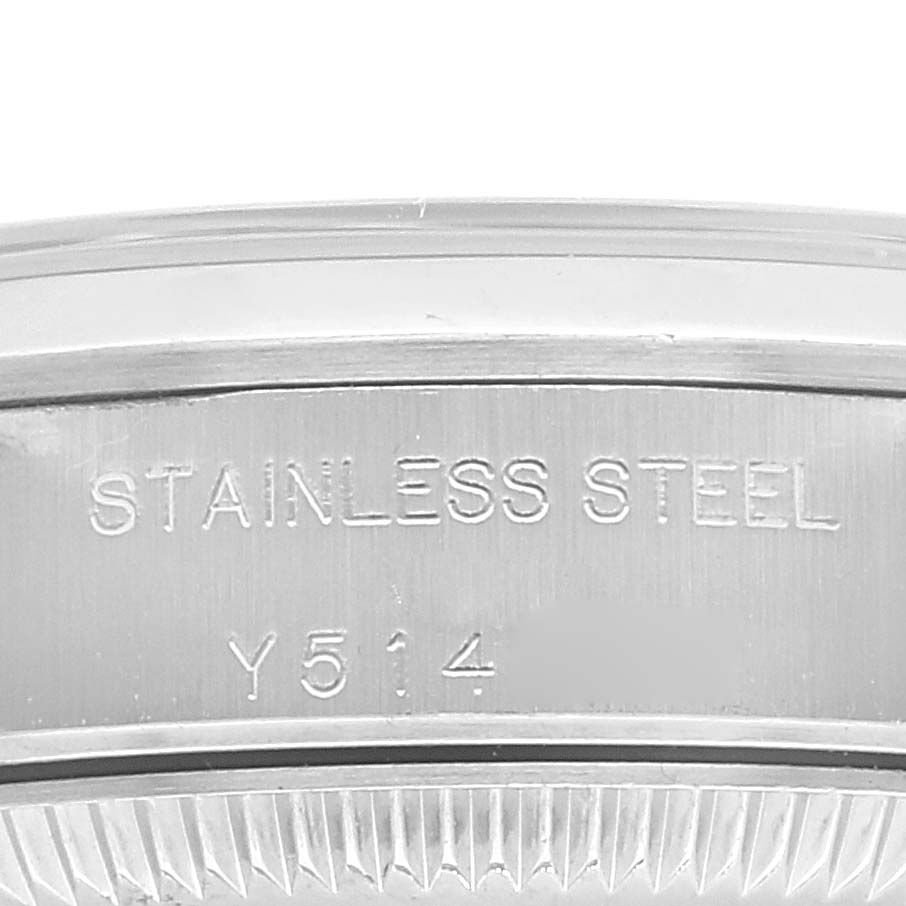 This image shows a close-up of the stainless steel back casing of a Rolex Oyster Perpetual 76080 Women
s Stainless Steel Pink Dial 76080 Women
s Stainless Steel Pink Dial watch.