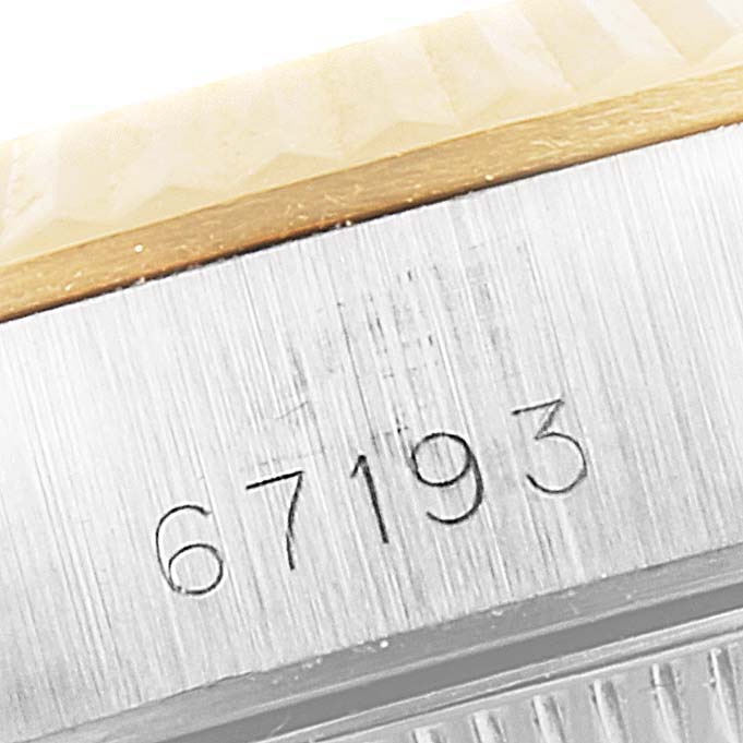 This image shows a close-up of the engraved serial number "67193" on the case of a Rolex Oyster Perpetual 67193 Women's Steel and Gold (two tone) White Dial 67193 Women's Steel and Gold (two tone) White Dial watch.