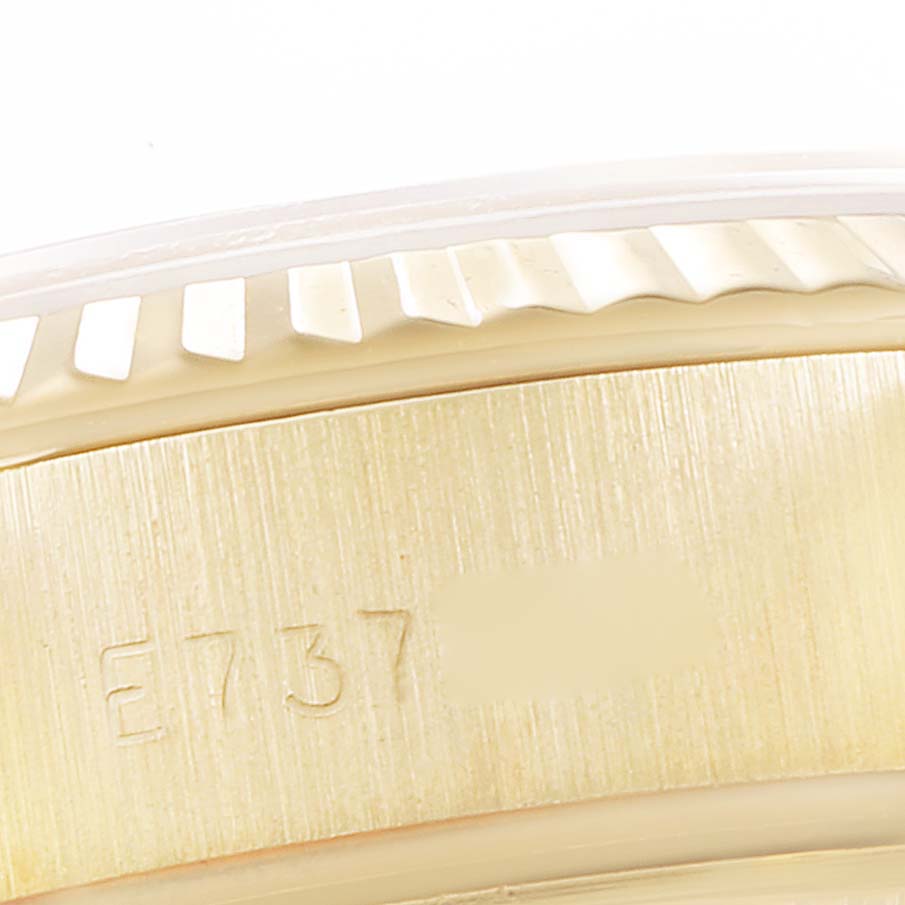 This image shows a close-up of the case side and bezel of the Rolex President 69178 Women
s Yellow Gold Champagne Dial 69178 Women
s Yellow Gold Champagne Dial model, highlighting the engraved serial number.