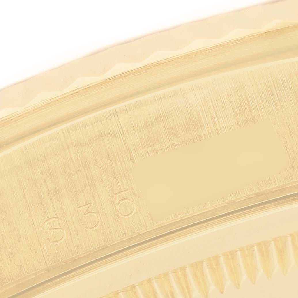This image shows a detailed close-up of the bezel edge and engraved numbers on a Rolex President 18238 Men's Yellow Gold Champagne Dial model.