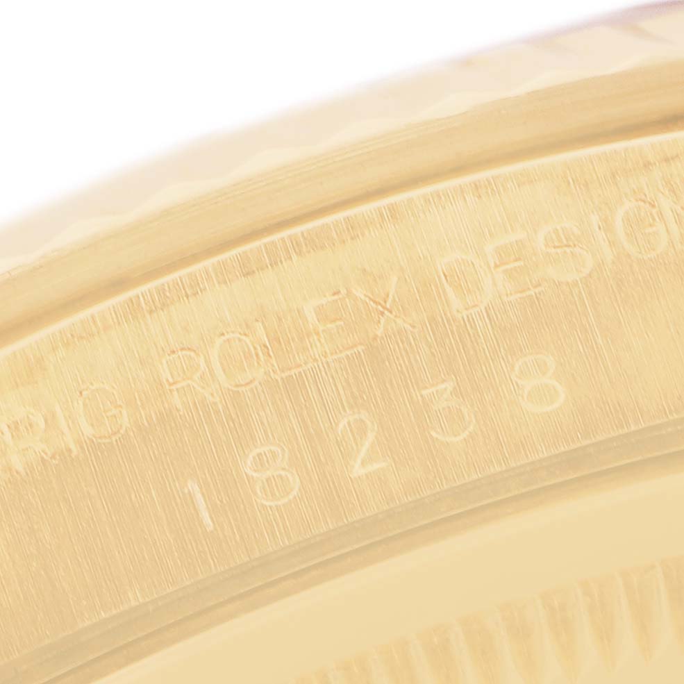 The image shows a close-up of the Rolex President 18238 Men's Yellow Gold Champagne Dial's case with engraved serial and model numbers.