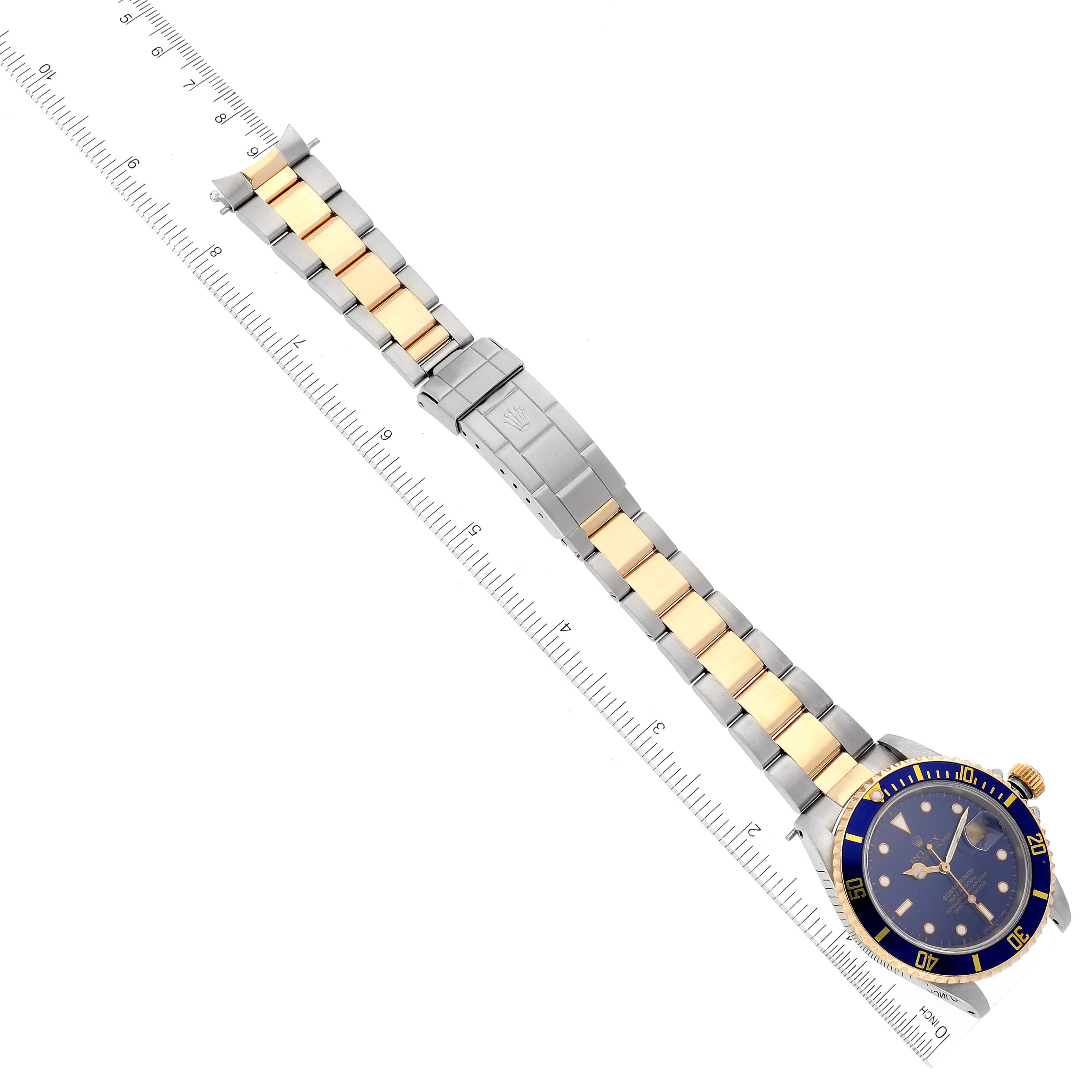 The Rolex Submariner 16613 Men's Steel and Gold (two tone) Blue Dial 16613 Men's Steel and Gold (two tone) Blue Dial watch is shown from a top-down angle, featuring the full band and the face including the bezel.