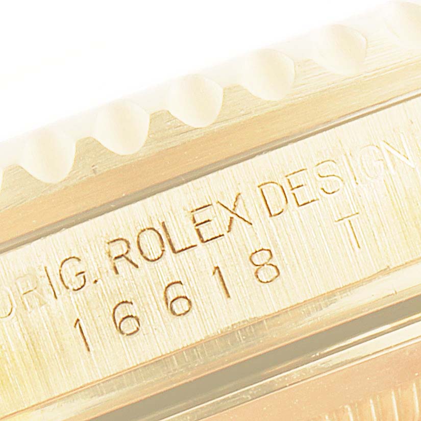 The image shows a close-up of the side view of a Rolex Submariner 16618 Men
s Yellow Gold Blue Dial 16618 Men
s Yellow Gold Blue Dial model, highlighting the engraved model number and design details.