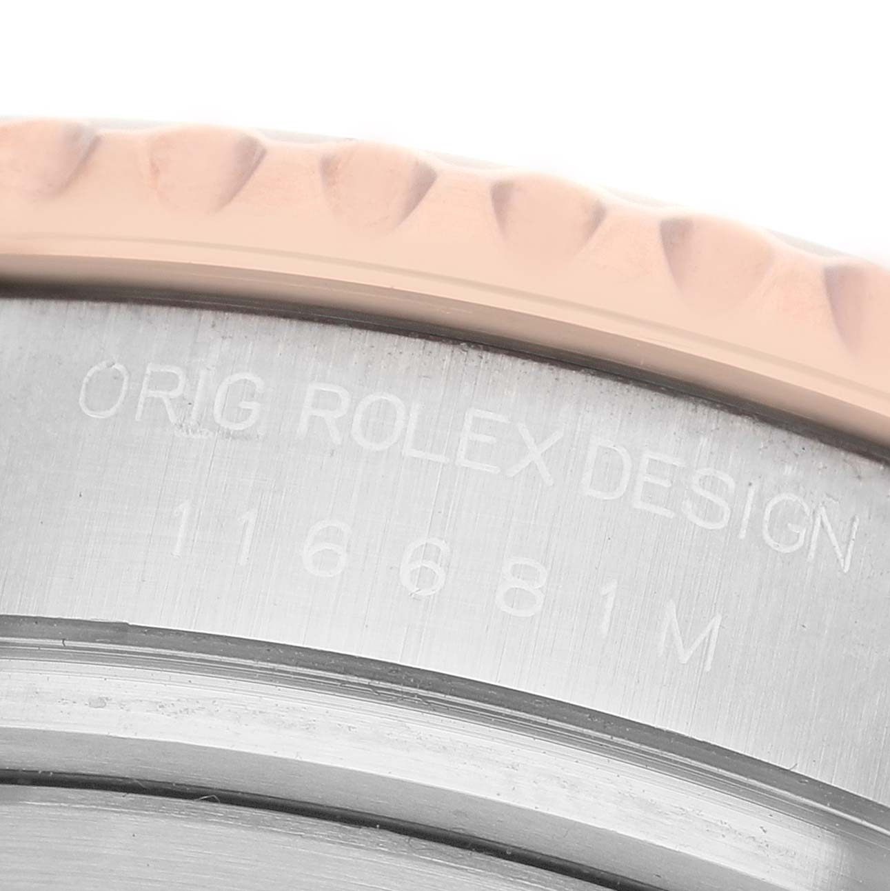 The image shows a close-up of the side of a Rolex Yacht-Master 116681M Men's Steel and Gold (two tone) White Dial, focusing on the bezel and engraved text.