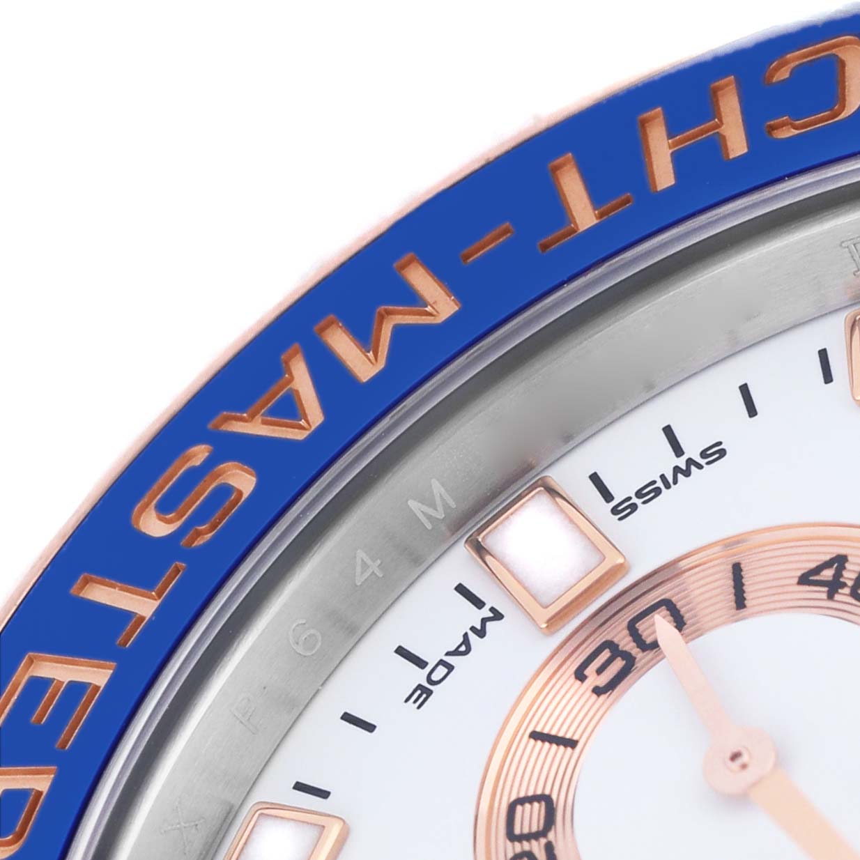 The image shows a close-up of the Rolex Yacht-Master 116681M Men's Steel and Gold (two tone) White Dial's bezel and part of the dial, highlighting the blue and gold details.
