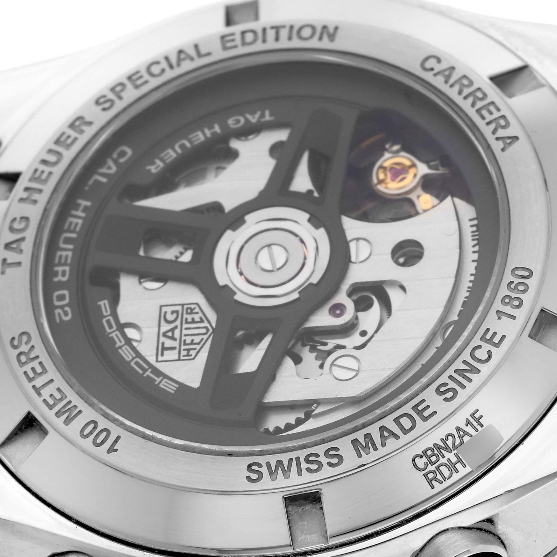 The image shows the back of a Tag Heuer Carrera CBN2A1F.FC6492 Men's Stainless Steel Grey Dial CBN2A1F.FC6492 Men's Stainless Steel Grey Dial watch, highlighting its exposed movement and engravings on the case back.