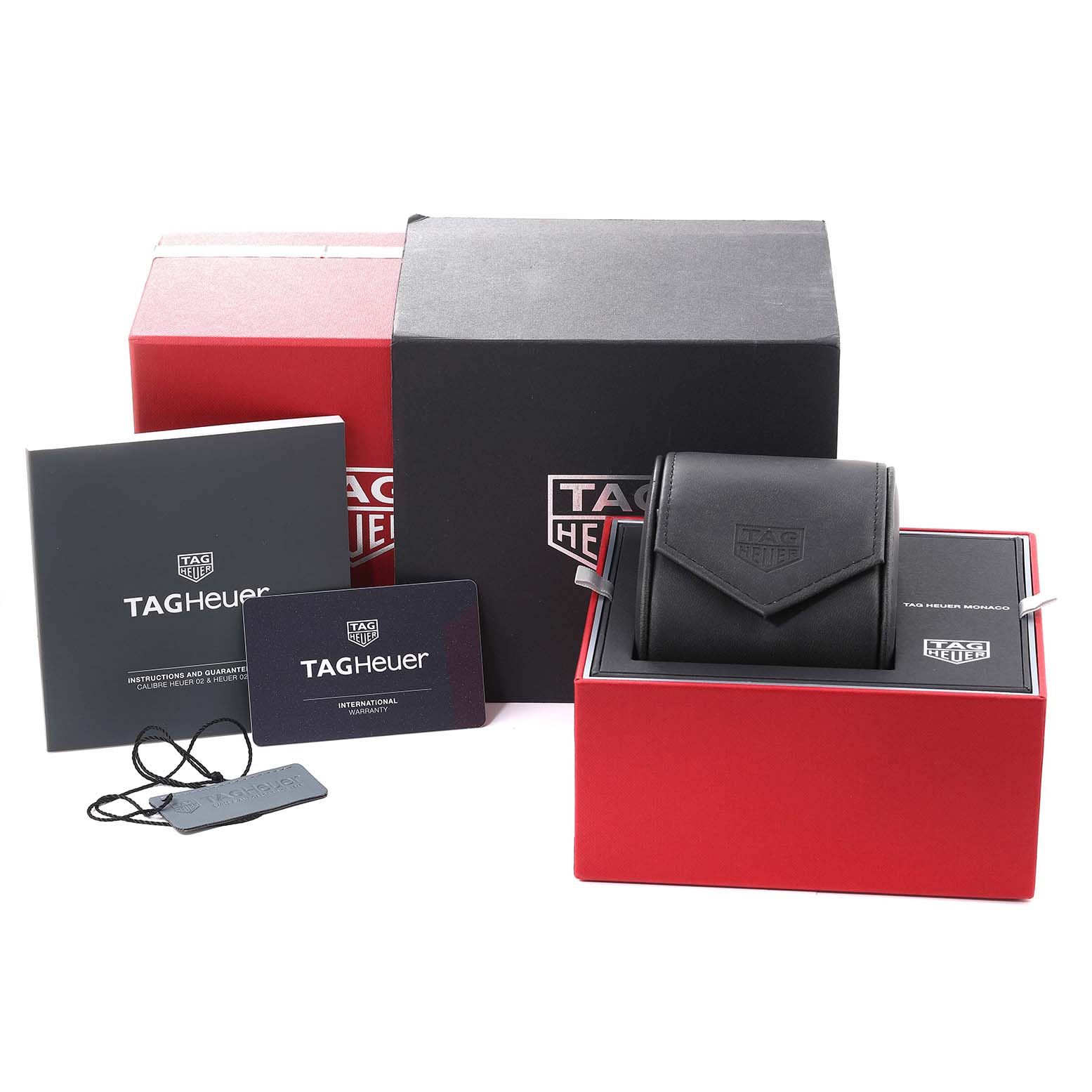 The image shows the Tag Heuer Monaco CBL2113 Men's Stainless Steel Black Dial CBL2113 Men's Stainless Steel Black Dial watch case, box, warranty card, instruction booklet, and a hang tag.
