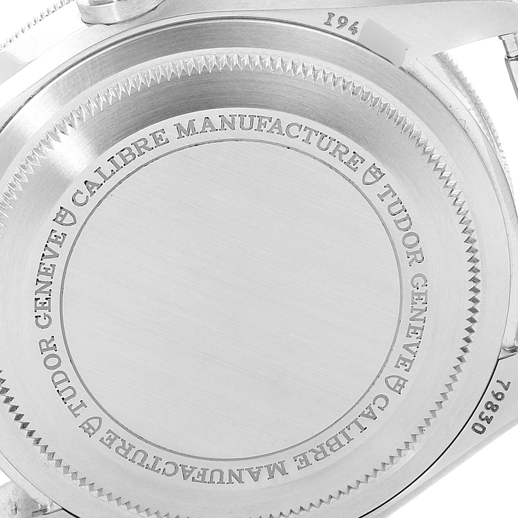 The image shows the back case of the Tudor Heritage Black Bay 79830RB Men's Stainless Steel Black Dial 79830RB Men's Stainless Steel Black Dial watch, highlighting its engravings and brushed finish.