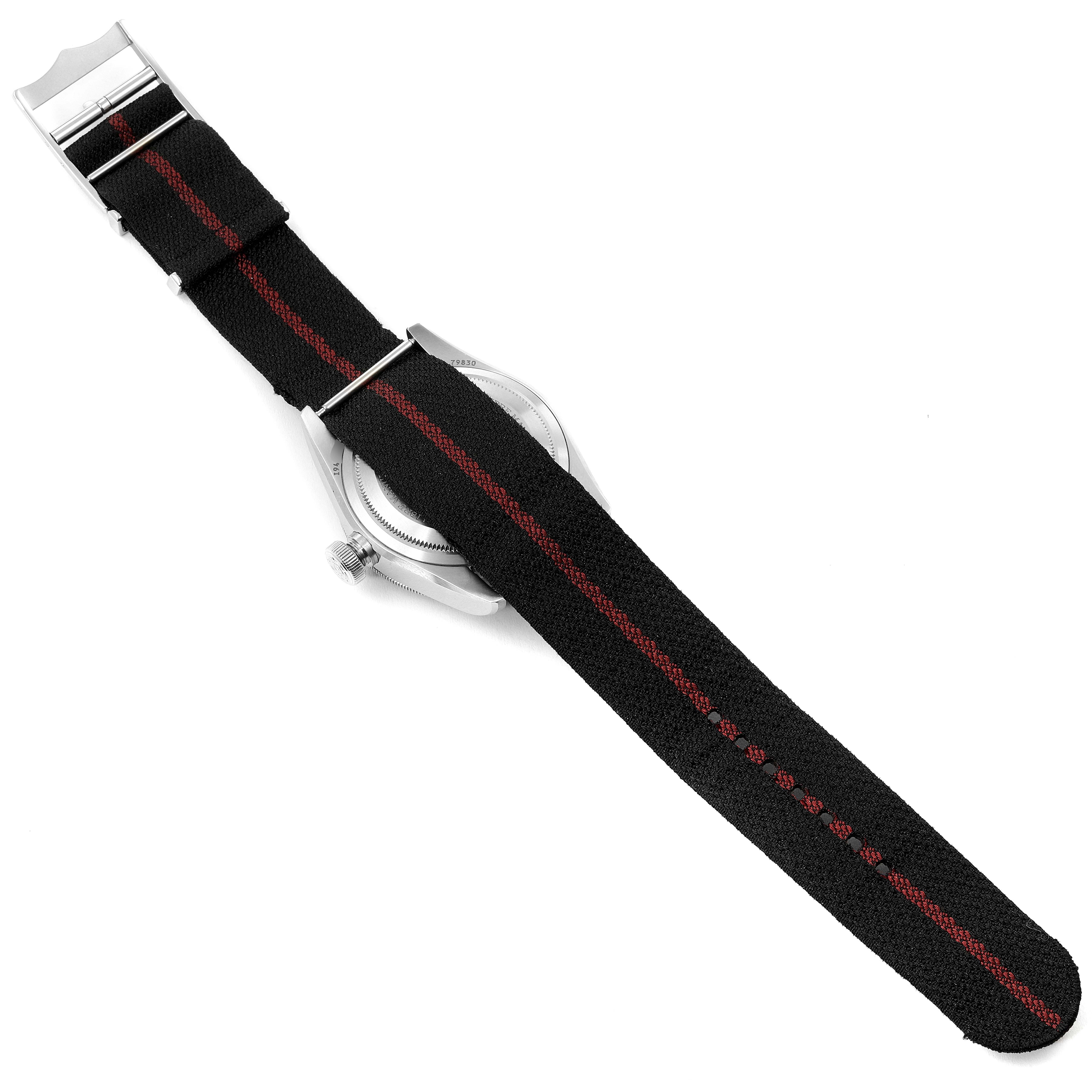 The image shows the back view of the Tudor Heritage Black Bay 79830RB Men's Stainless Steel Black Dial 79830RB Men's Stainless Steel Black Dial watch, focusing on its NATO strap with a red stripe.