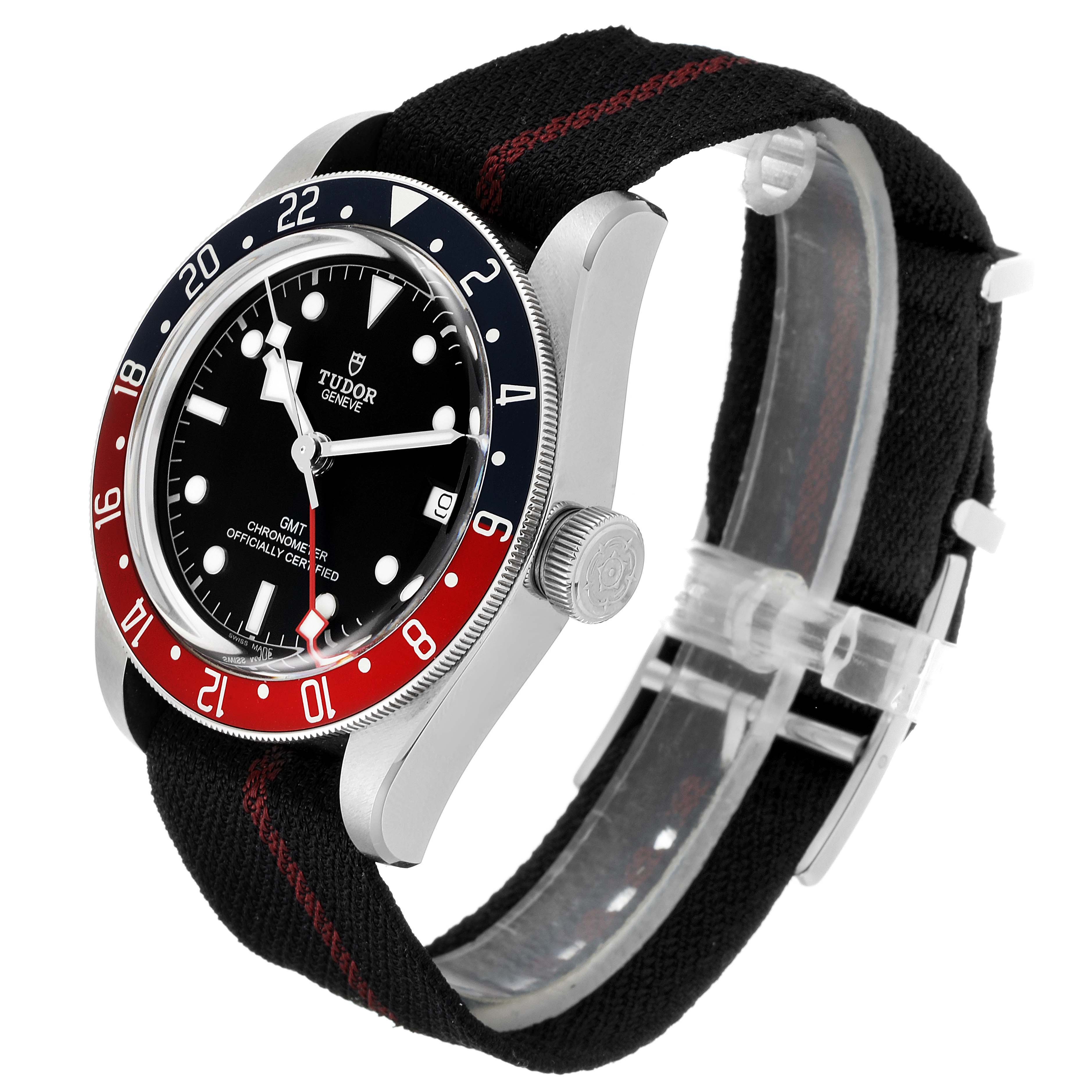 The Tudor Heritage Black Bay 79830RB Men's Stainless Steel Black Dial 79830RB Men's Stainless Steel Black Dial watch is shown from a three-quarter angle, highlighting the bezel, dial, and fabric strap.