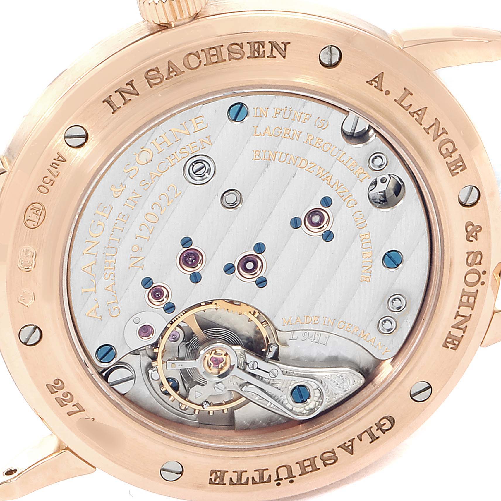 The image shows the back of the Saxonia watch by A. Lange & Söhne, highlighting the intricate movement and engravings.