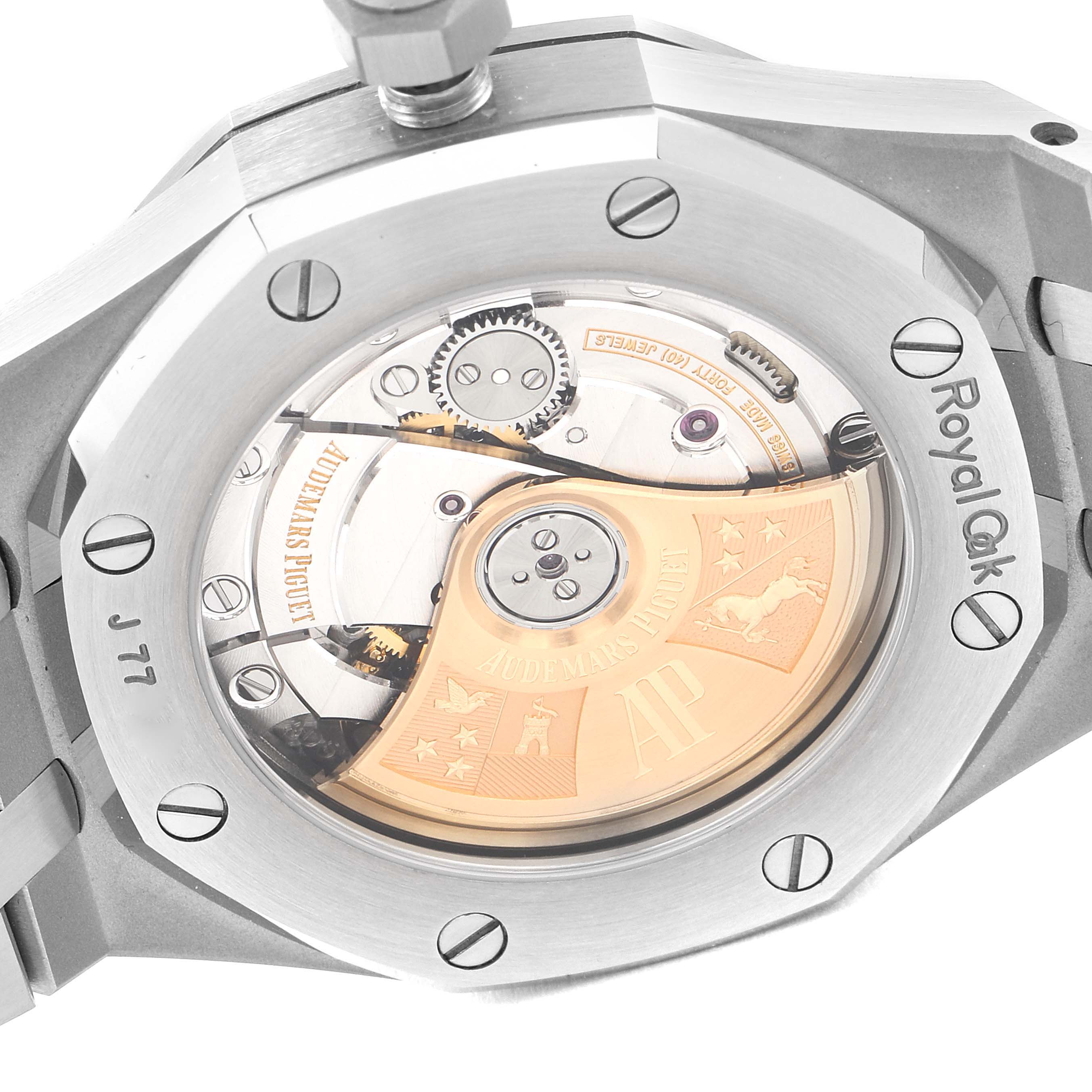 The image shows the rear view of the Royal Oak model by Audemars Piguet, highlighting its movement components and engraved rotor.