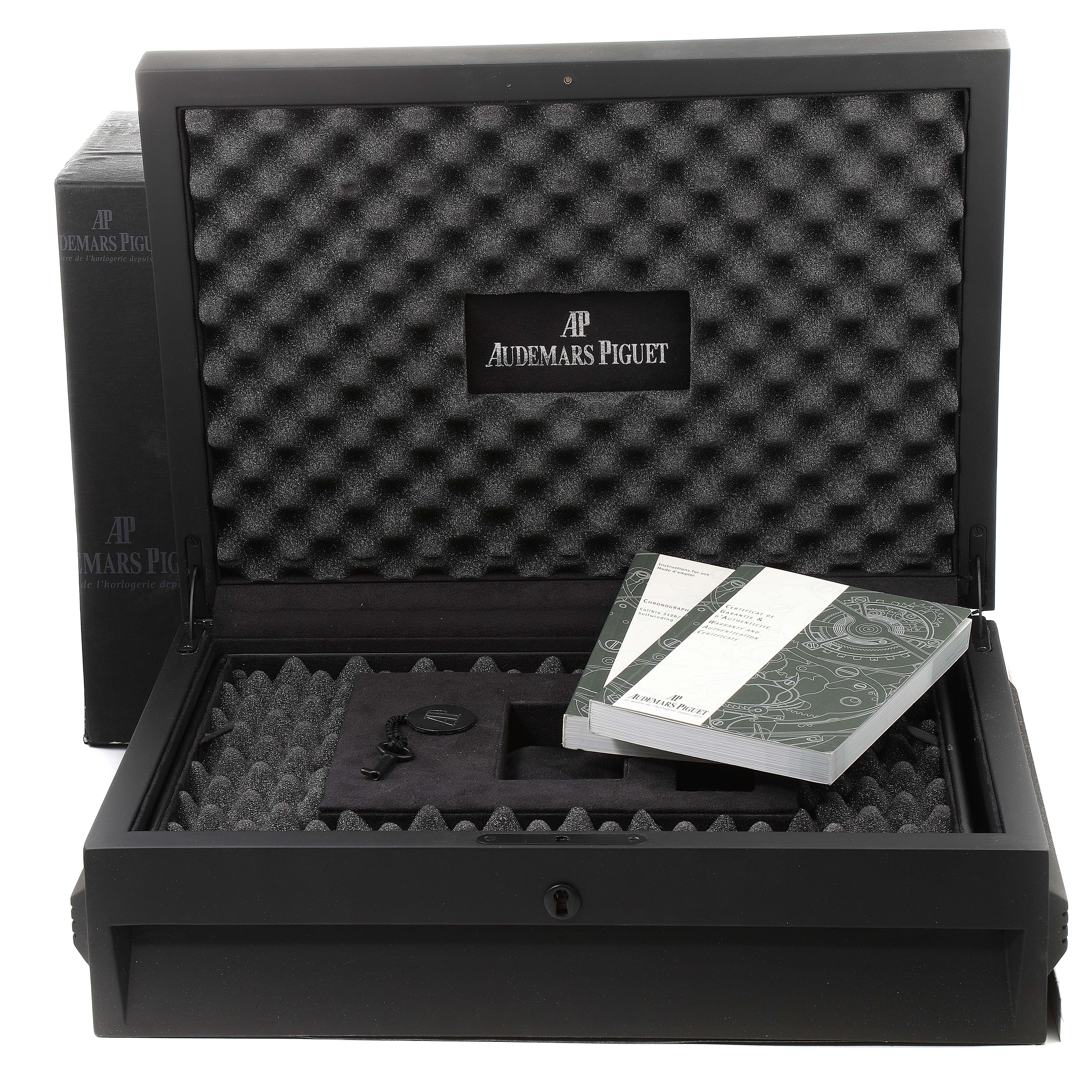 The image shows an open black box for a Royal Oak Offshore model by Audemars Piguet, displaying foam inserts, booklets, and accessories.