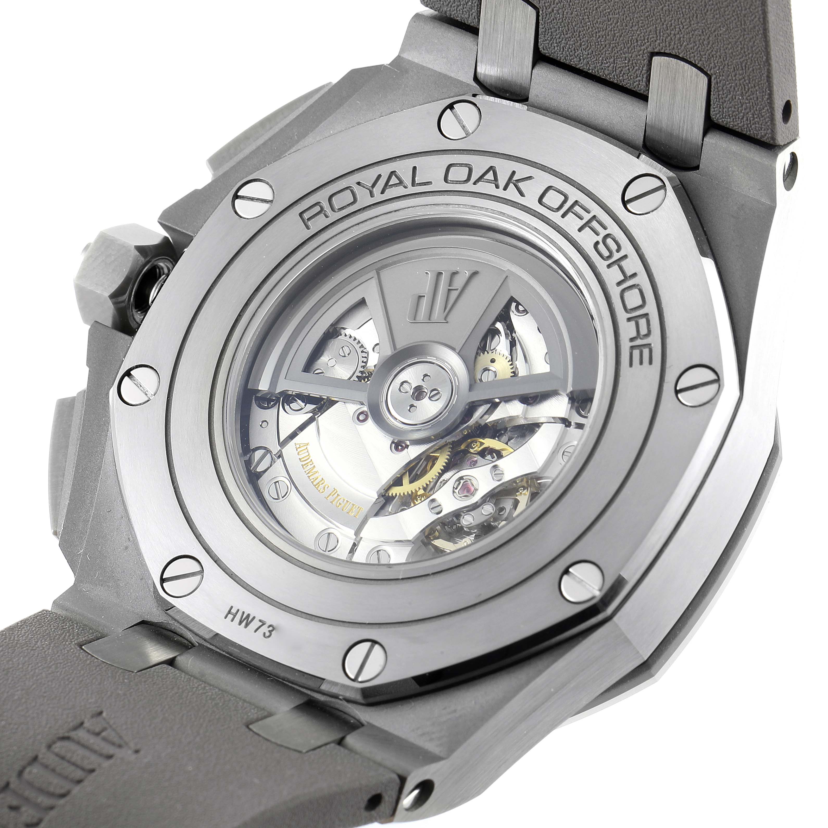 The image shows the back of an Audemars Piguet Royal Oak Offshore 26400IO.OO.A004CA.02 Men
s Titanium Grey Dial 26400IO.OO.A004CA.02 Men
s Titanium Grey Dial watch, featuring its visible movement and intricate mechanics.