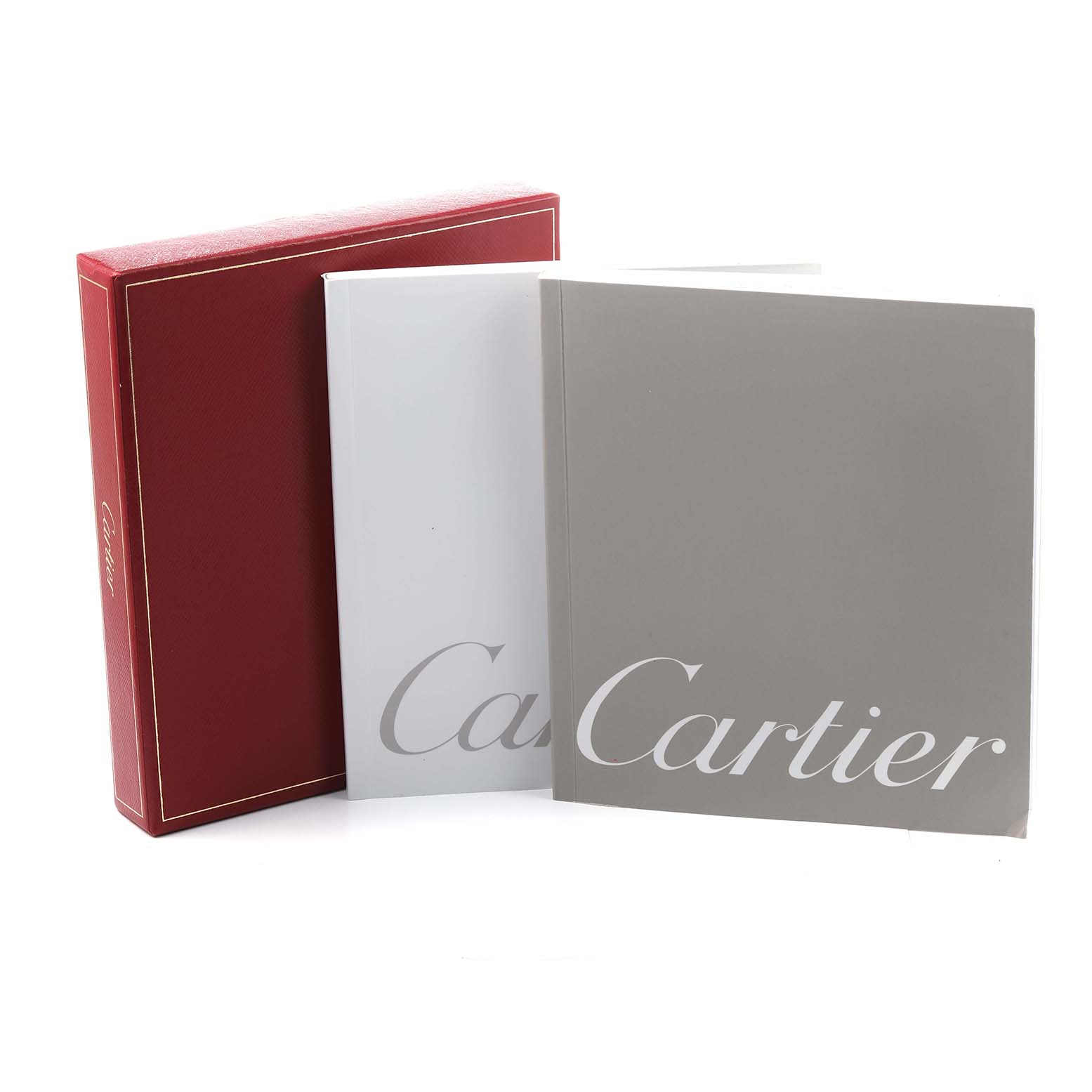 The image shows the packaging and booklets for the Cartier Roadster W62026Y4 Women's Steel and Gold (two tone) Transparent Dial watch, featuring a red box and two manuals.