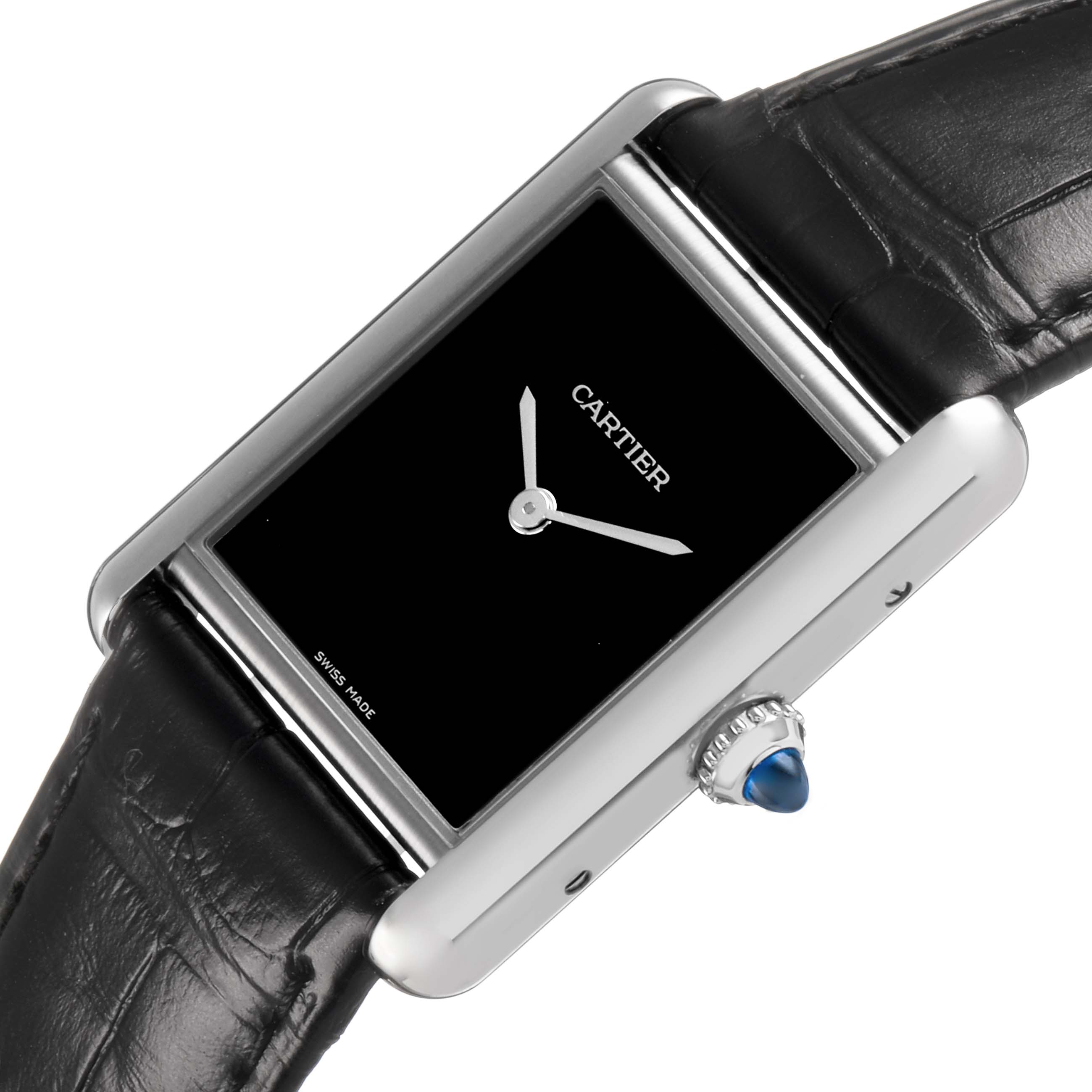 The Cartier Tank Must WSTA0072 Women's Stainless Steel Black Dial watch is shown at a slight angle, displaying its black dial, silver case, crown with a blue cabochon, and black strap.