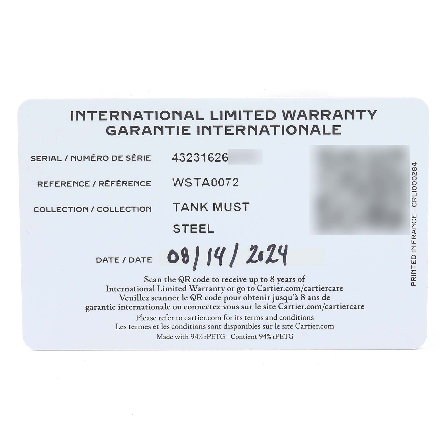 The image shows an International Limited Warranty card for a Cartier Tank Must WSTA0072 Women's Stainless Steel Black Dial watch, displaying serial and reference numbers.