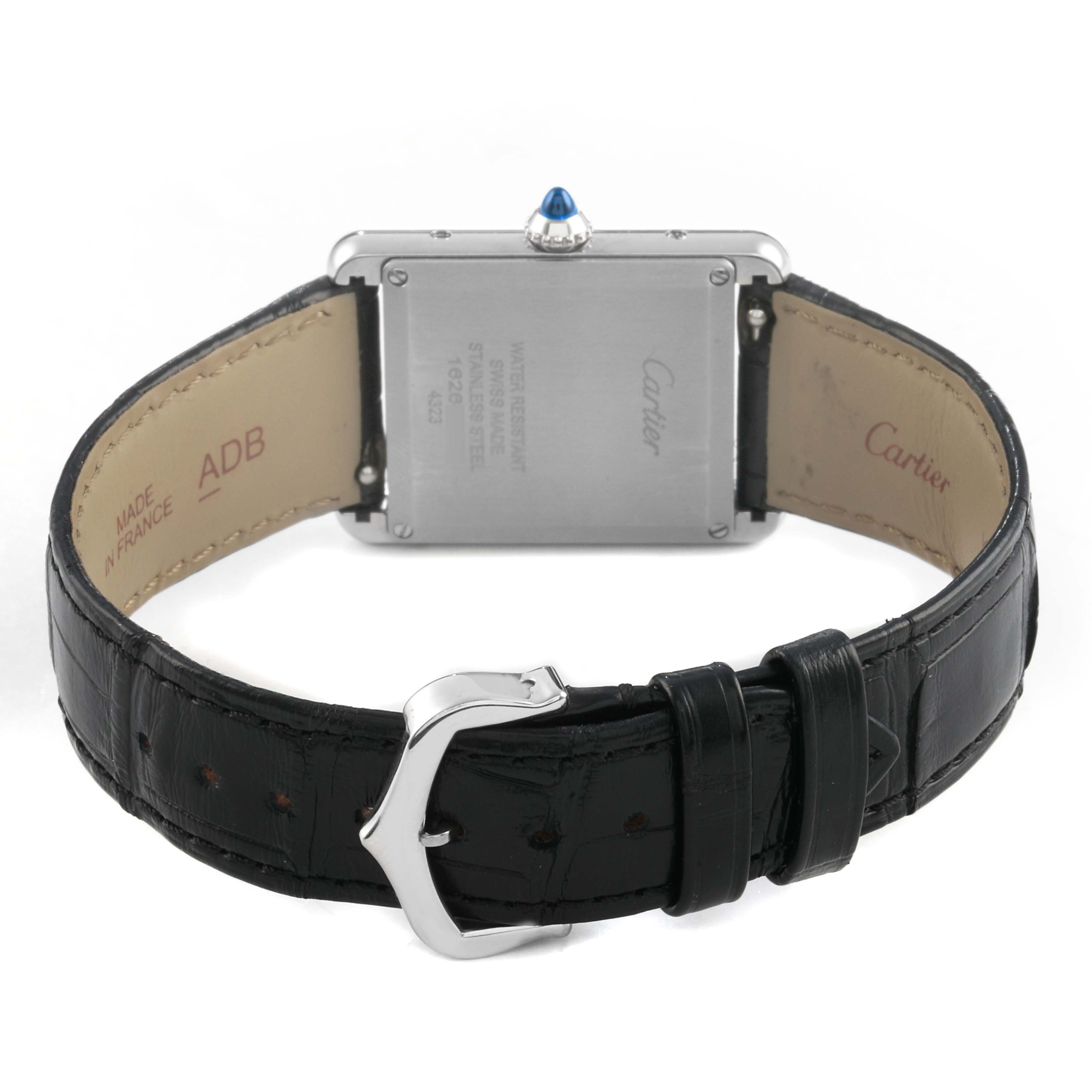 The Cartier Tank Must WSTA0072 Women's Stainless Steel Black Dial watch is shown from the back, highlighting the case back, leather strap, and buckle.