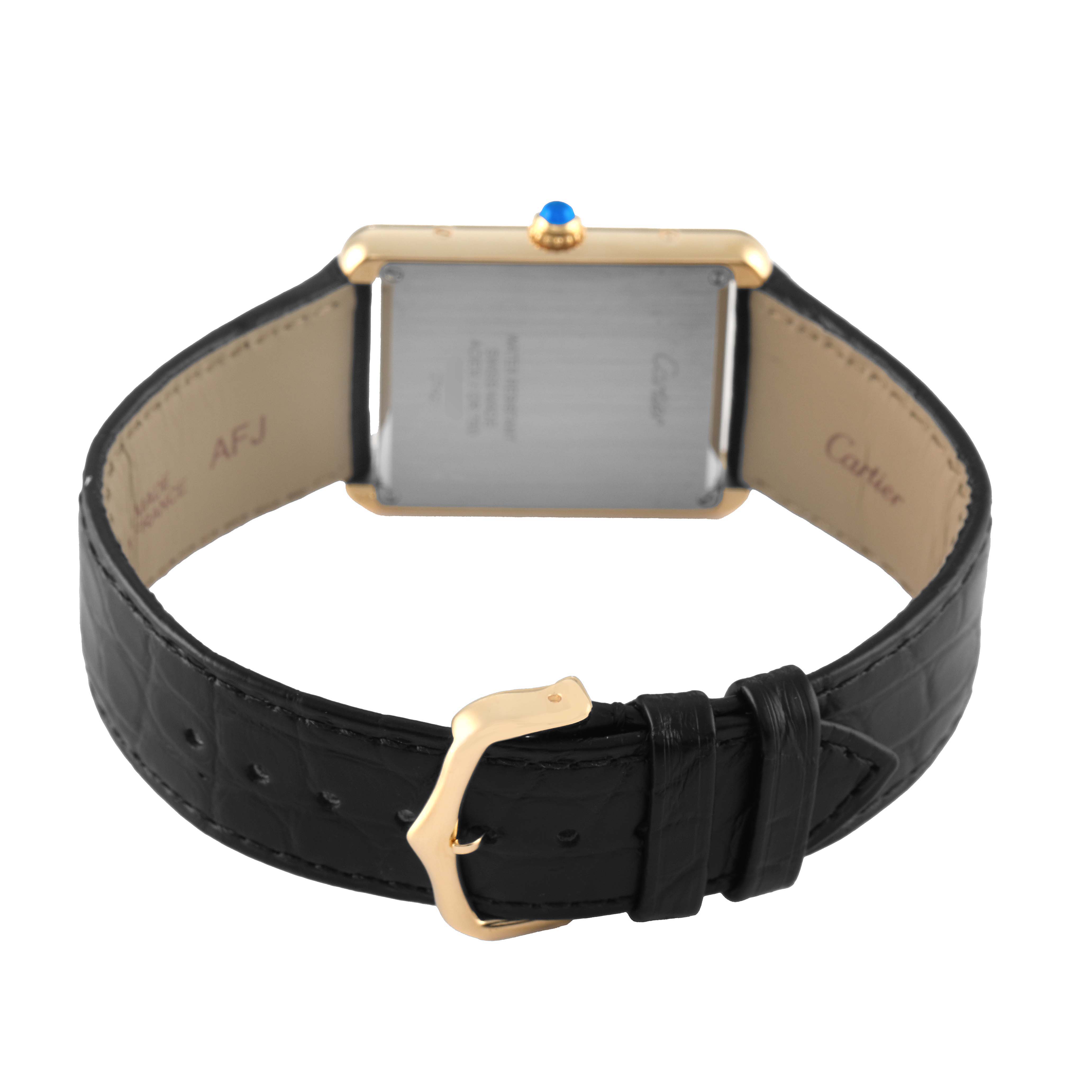 The Cartier Tank Solo W1018855 Men's Yellow Gold Silver Dial watch is shown from the back, featuring the buckle and black leather strap.