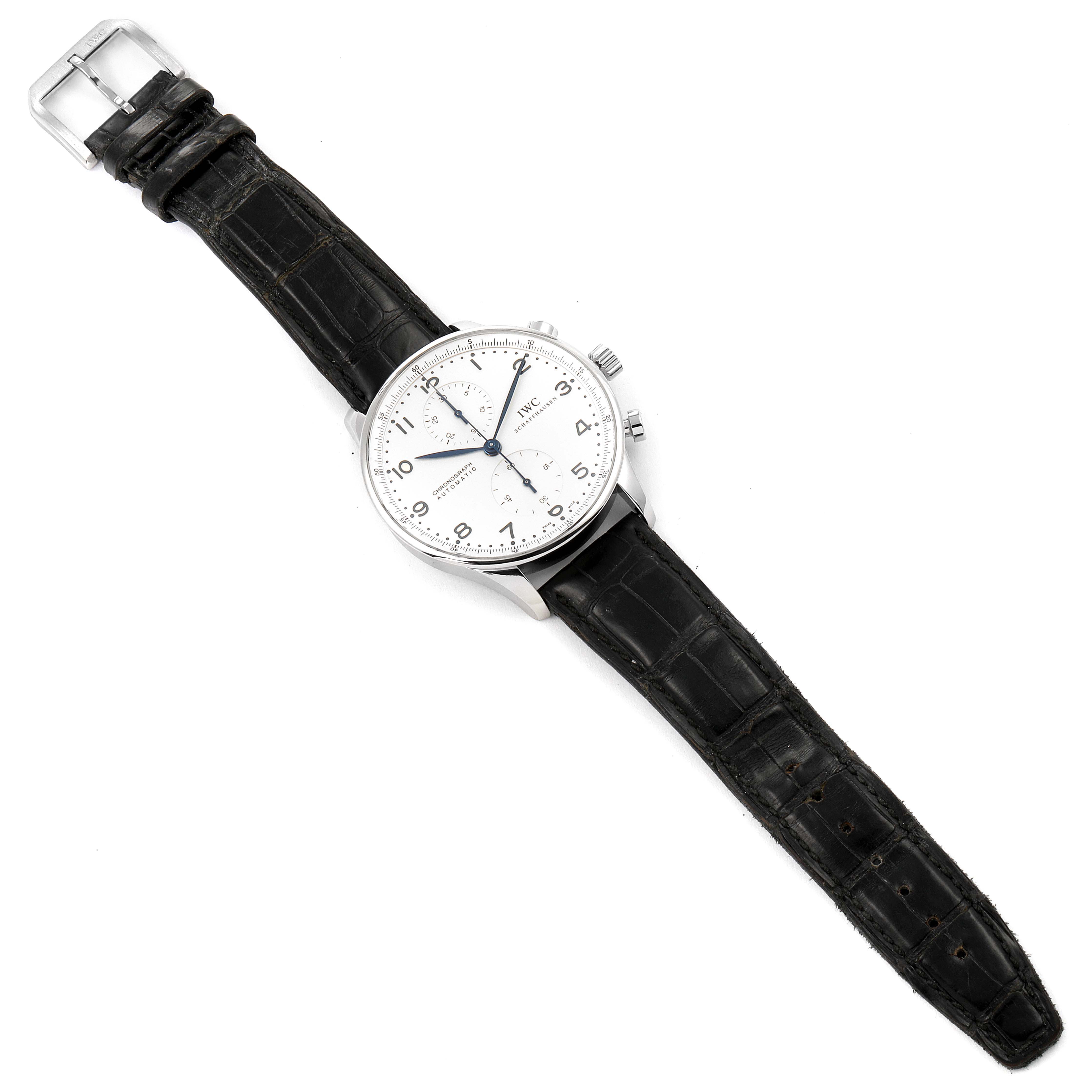 The image shows an IWC Portuguese IW371446 Men's Stainless Steel Silver Dial IW371446 Men's Stainless Steel Silver Dial model watch from a top-down angle, displaying its dial, case, and black leather strap.