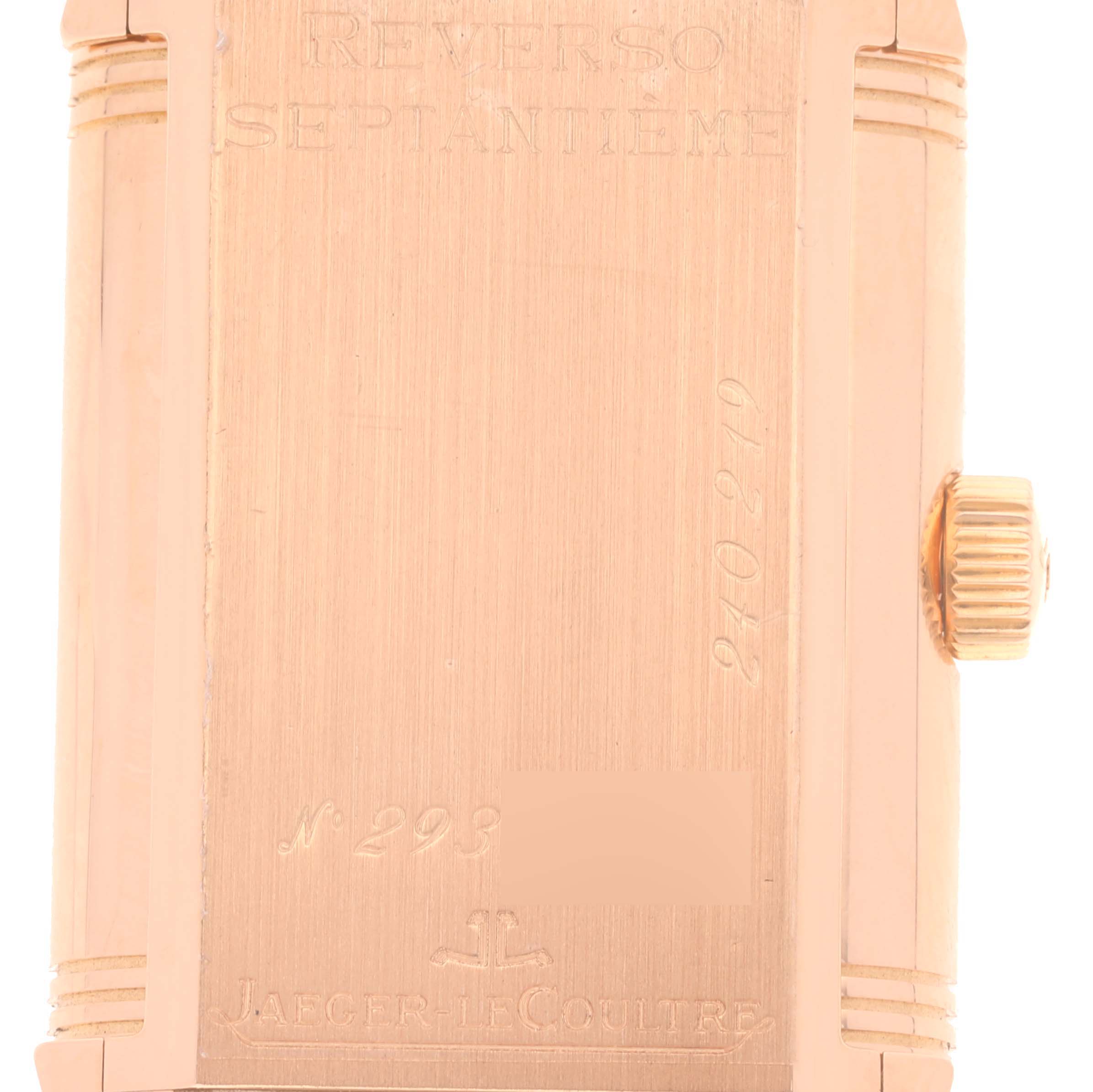 The image shows the engraved backside and crown of a Jaeger LeCoultre Reverso Q3002420 Men's Rose Gold Silver Dial Q3002420 Men's Rose Gold Silver Dial watch in a vertical angle.