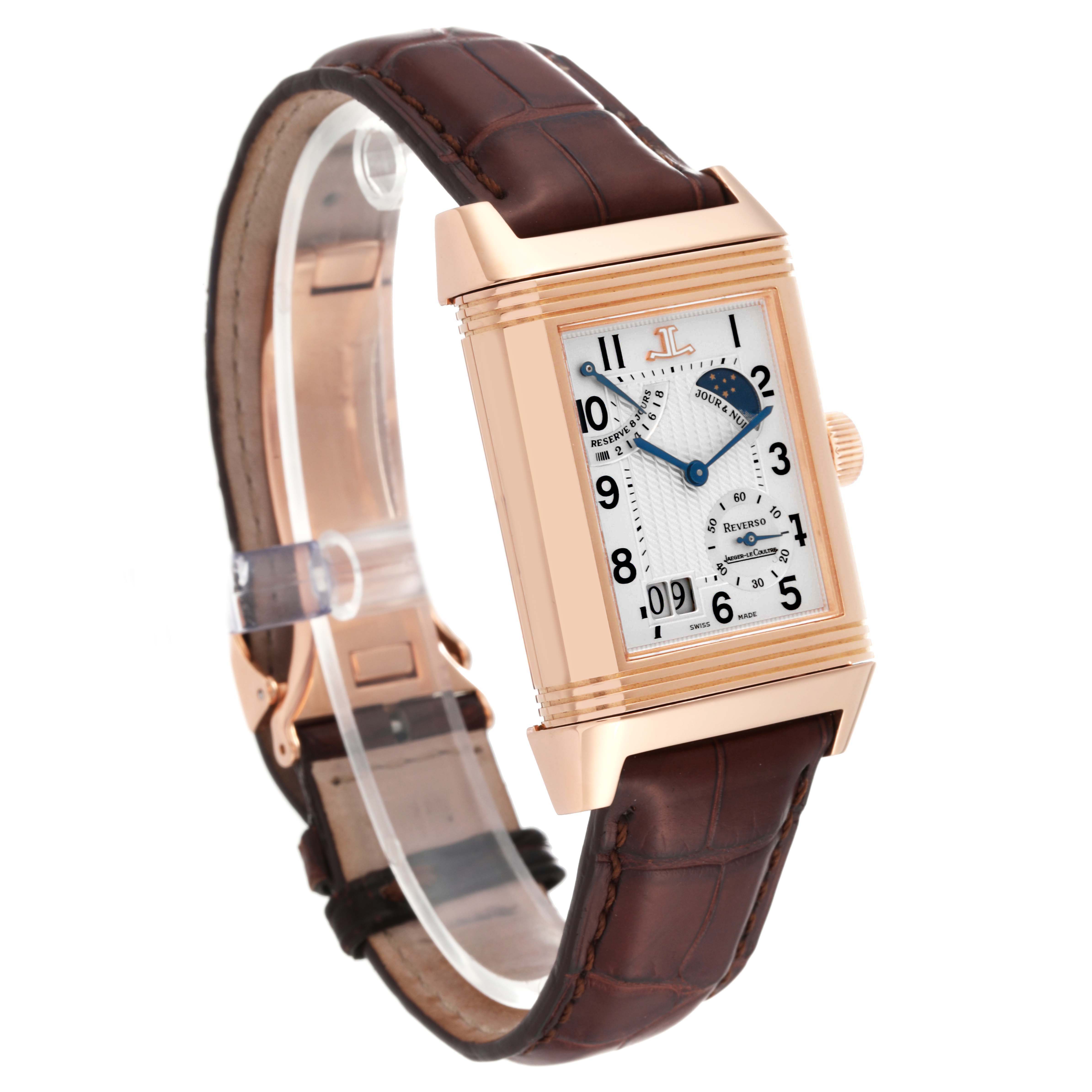 The Jaeger LeCoultre Reverso Q3002420 Men's Rose Gold Silver Dial watch is shown at an oblique angle, highlighting its rectangular face, brown leather strap, and side crown.