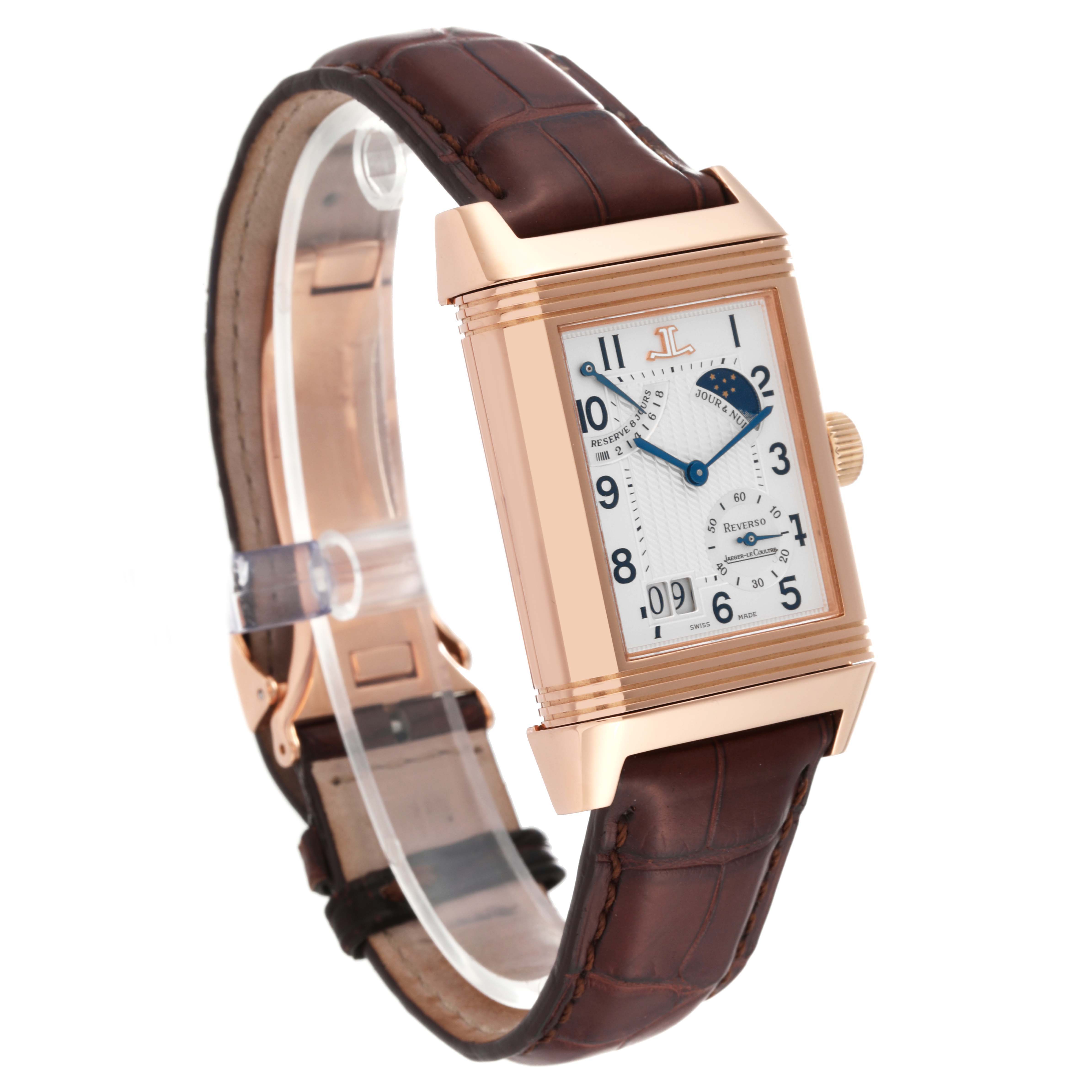 The Jaeger-LeCoultre Reverso watch is shown at an angle highlighting its face, rectangular case, brown leather strap, and crown.