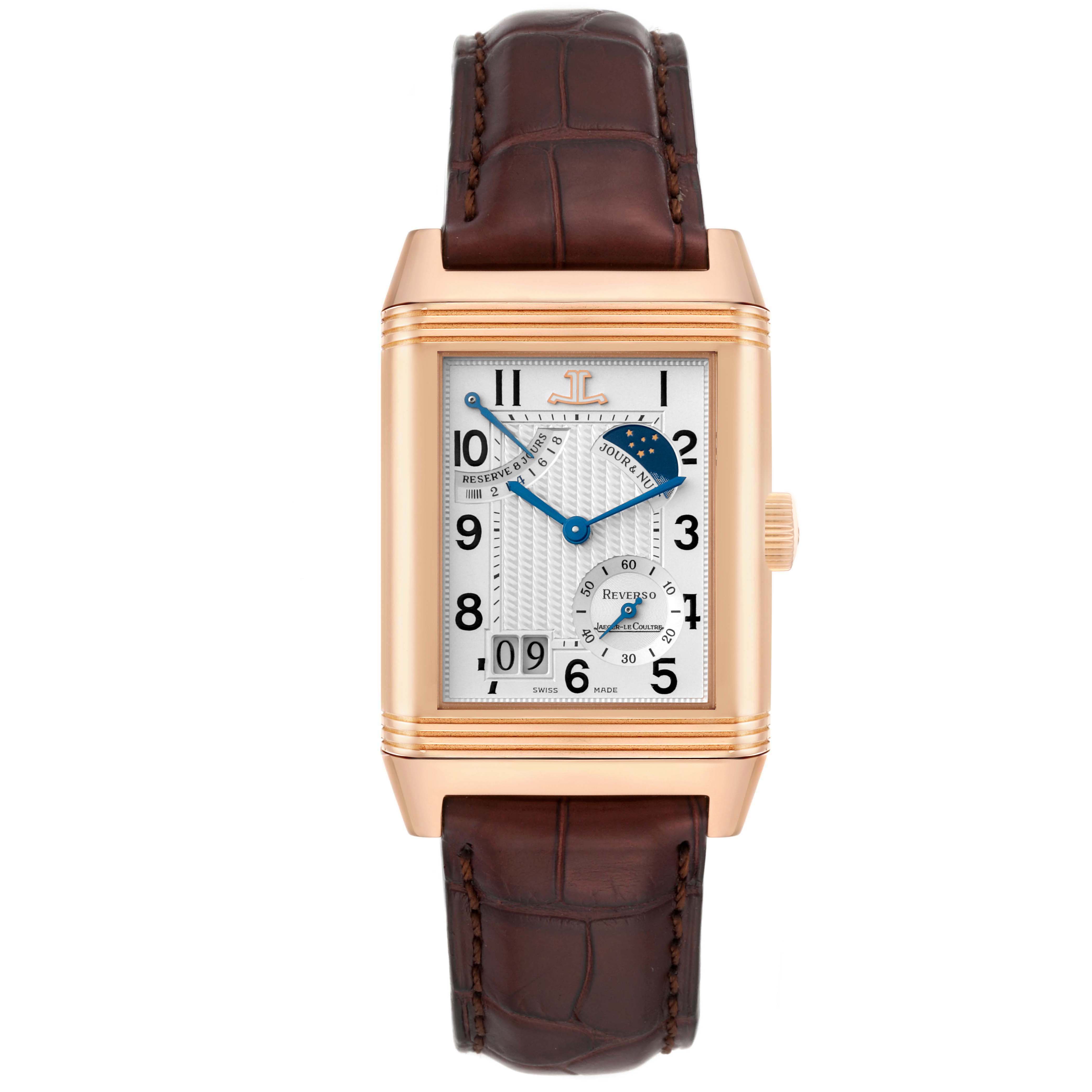 The Jaeger-LeCoultre Reverso watch is shown from the front, displaying its rectangular case, dial, and leather strap.