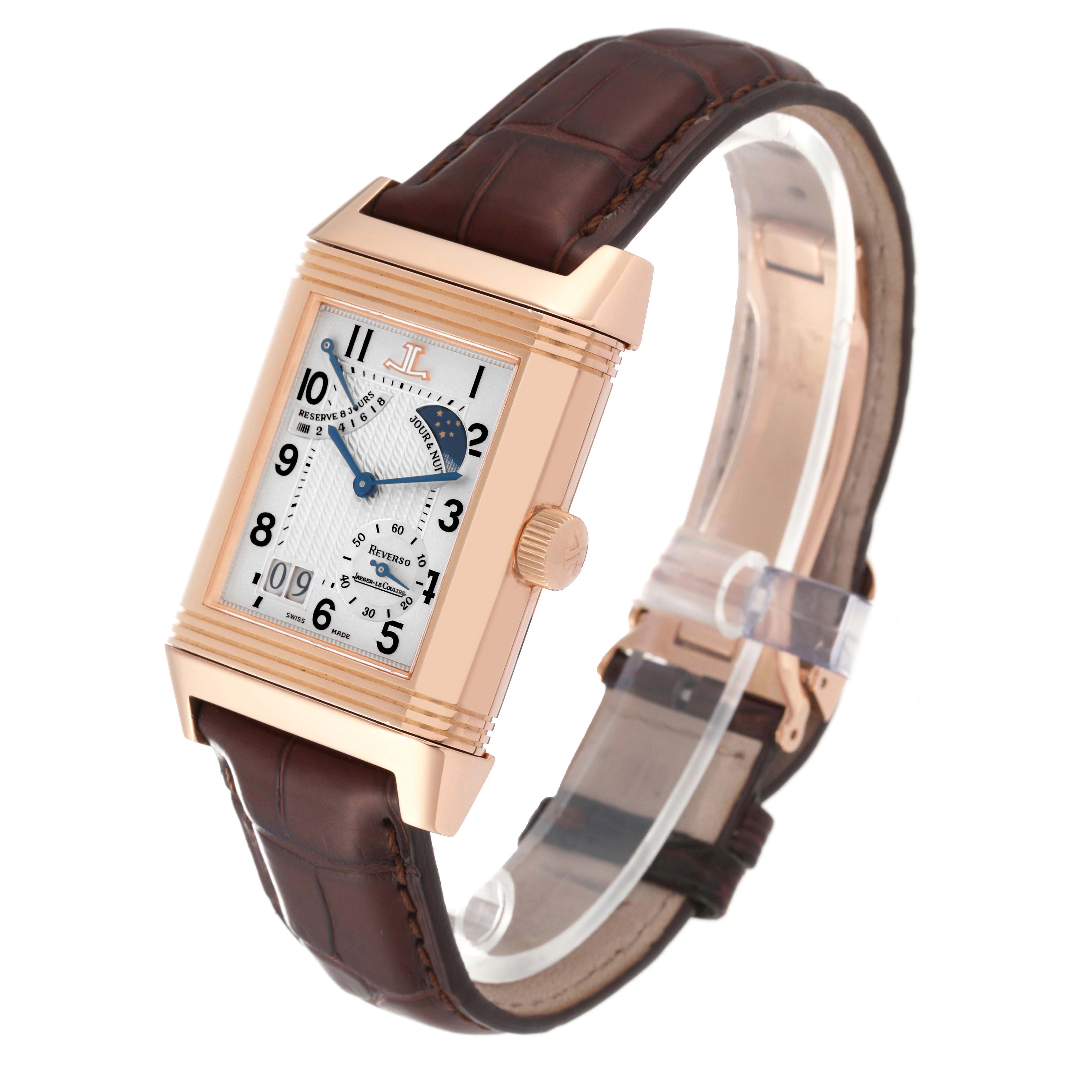 The Jaeger-LeCoultre Reverso watch is shown at a slight angle, highlighting its rectangular face, crown, and brown strap.