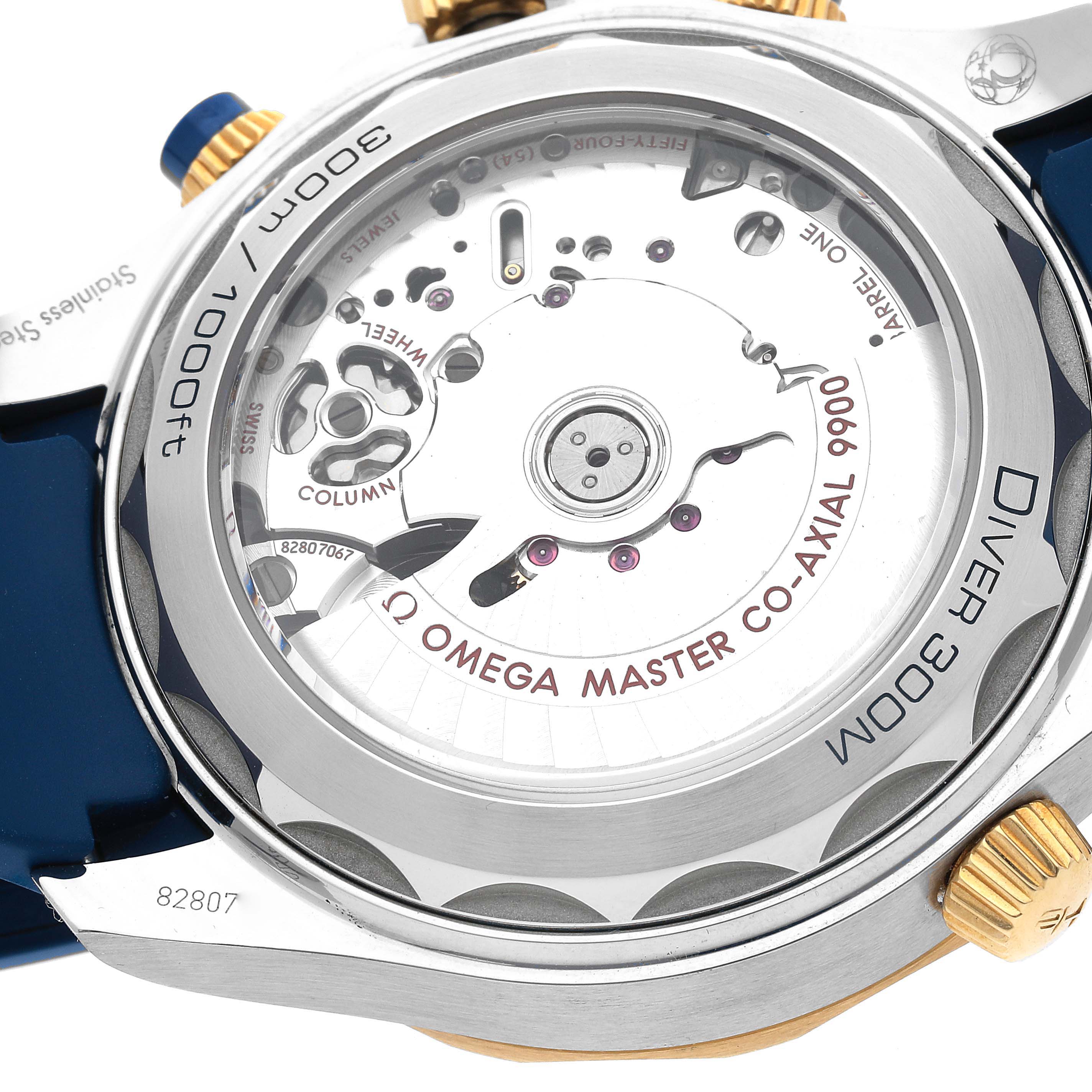 The image shows the back view of an Omega Seamaster 210.22.44.51.03.001 Men's Steel and Gold (two tone) Blue Dial 210.22.44.51.03.001 Men's Steel and Gold (two tone) Blue Dial watch, highlighting its internal mechanics and the inscription "OMEGA MASTER CO-AXIAL 9900."