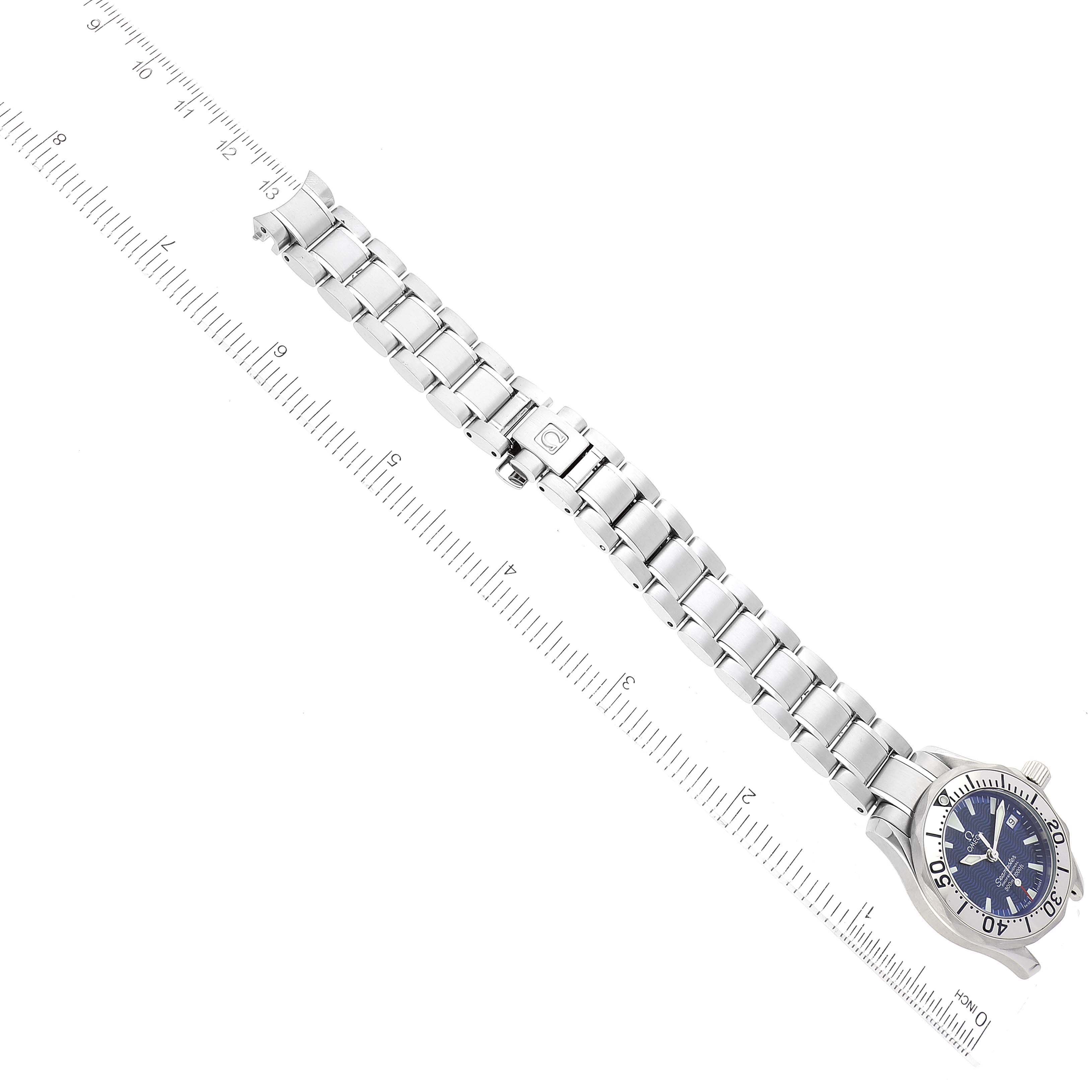 The Omega 2285.80.00 Women's Stainless Steel Blue Dial 2285.80.00 Women's Stainless Steel Blue Dial Seamaster Diver Quartz 28mm Steel Ladies Watch 2285.80.00 is shown from a top-down angle, displaying the entire watch and bracelet with rulers for scale.