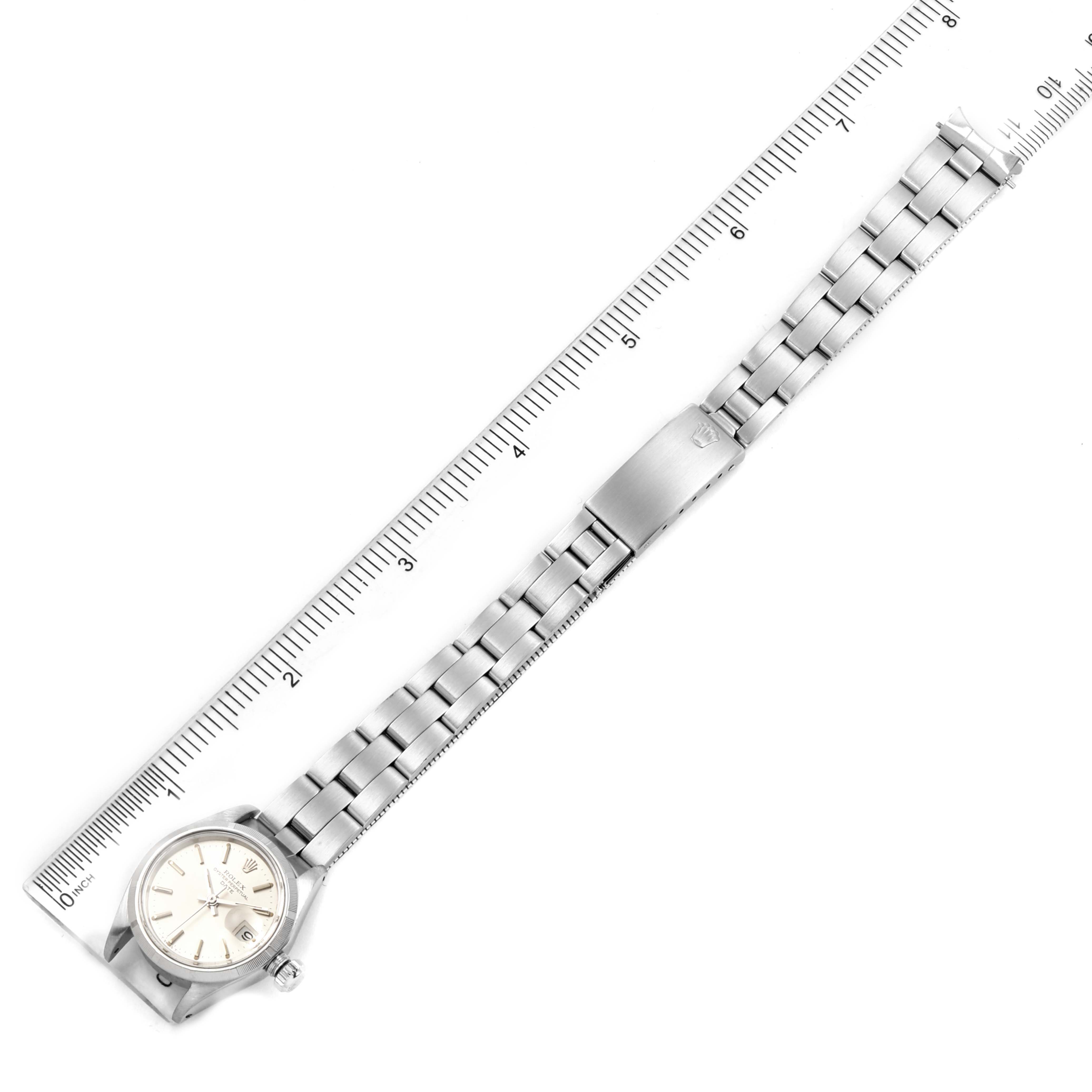 The image shows an overhead view of a Rolex Date 6919 Women
s Stainless Steel Silver Dial 6919 Women
s Stainless Steel Silver Dial model watch, displaying the dial and the metal bracelet.