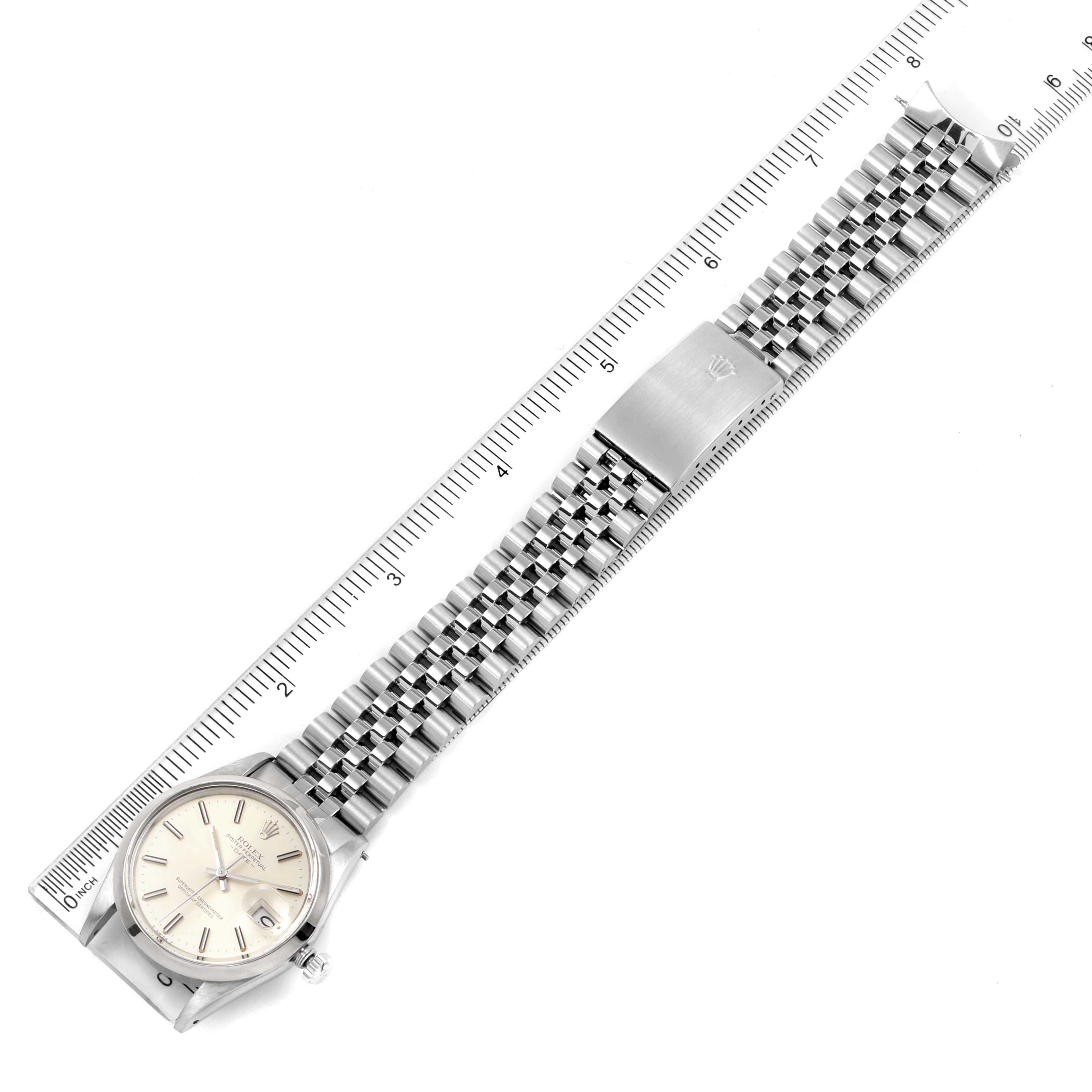The image shows a flat lay of a Rolex Date 15000 Men's Stainless Steel Silver Dial 15000 Men's Stainless Steel Silver Dial watch, highlighting the face, bracelet, and clasp components.