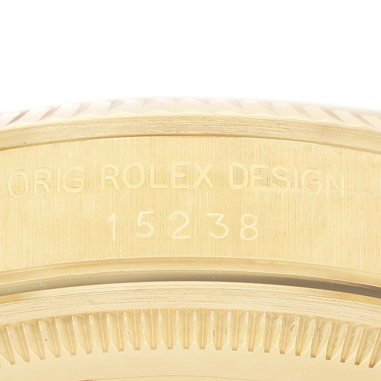 The image shows the side view of a Rolex Date 15238 Men's Yellow Gold Champagne Dial model, highlighting the engravings on the case.