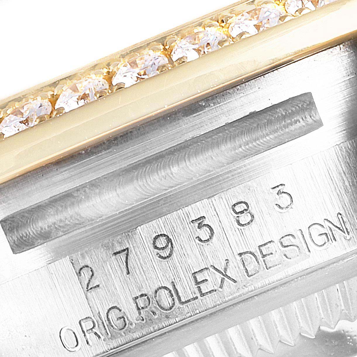 This close-up image shows the serial number and part of the diamond-studded bezel of a Rolex Datejust 279383 Women's Steel and Gold (two tone) Mother of Pearl Dial 279383 Women's Steel and Gold (two tone) Mother of Pearl Dial watch.