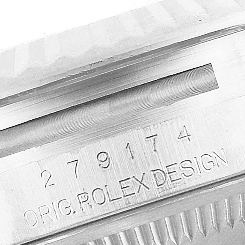 The image shows a close-up angle of the Rolex Datejust 279174 Women
s Stainless Steel Silver Dial 279174 Women
s Stainless Steel Silver Dial model, specifically displaying the serial number and "ORIG. ROLEX DESIGN" engraving.