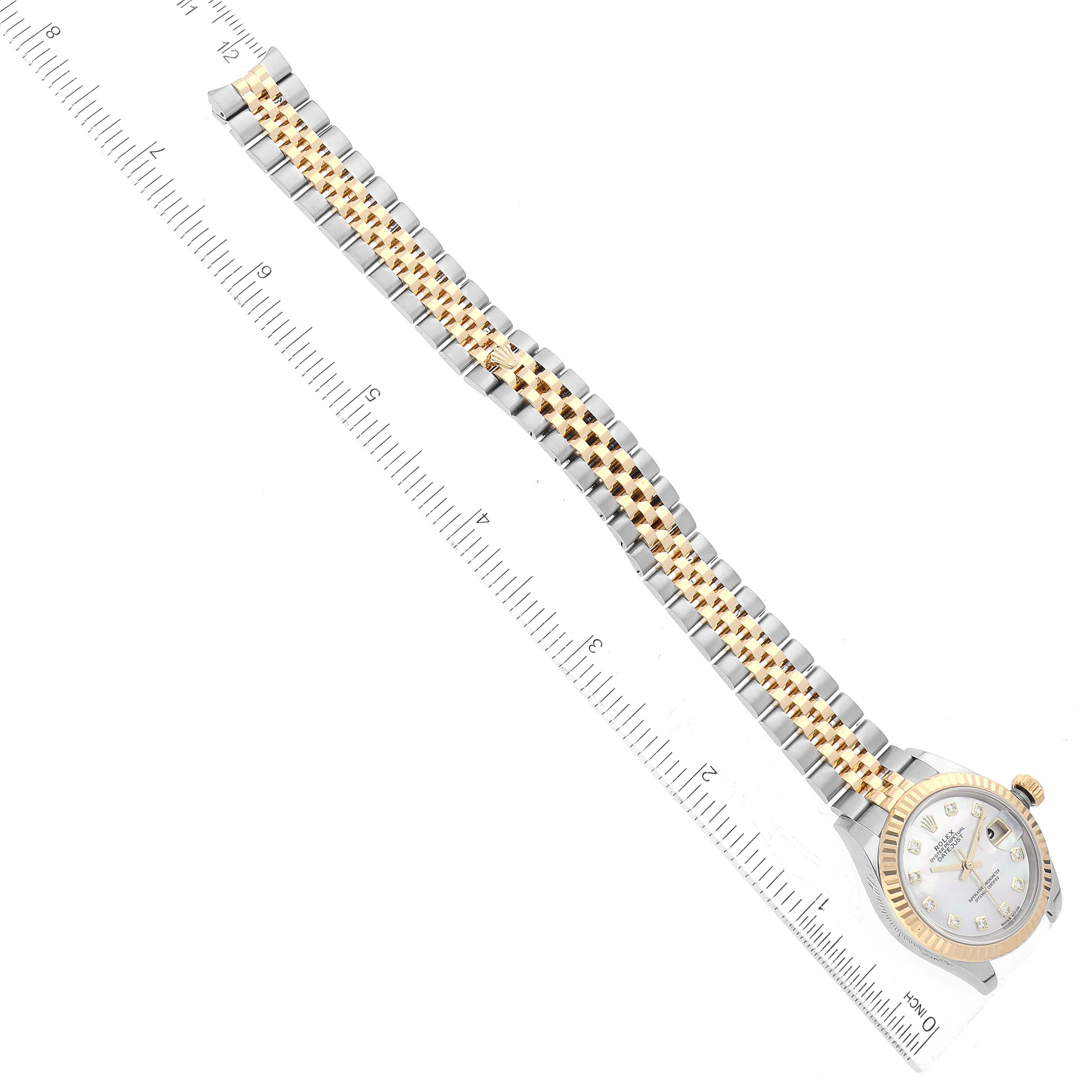 The image shows a Rolex Datejust 279173 Women's Steel and Gold (two tone) Mother of Pearl Dial 279173 Women's Steel and Gold (two tone) Mother of Pearl Dial watch laid flat with its bracelet alongside a ruler for scale.
