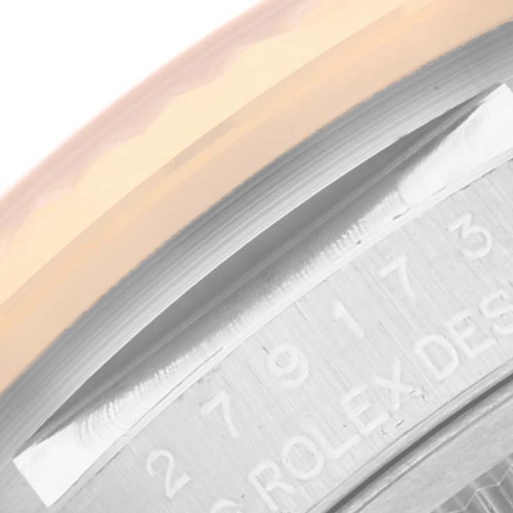 The image shows a close-up angle of the serial number engravings on the case of a Rolex Datejust 279173 Women's Steel and Gold (two tone) Mother of Pearl Dial 279173 Women's Steel and Gold (two tone) Mother of Pearl Dial watch.