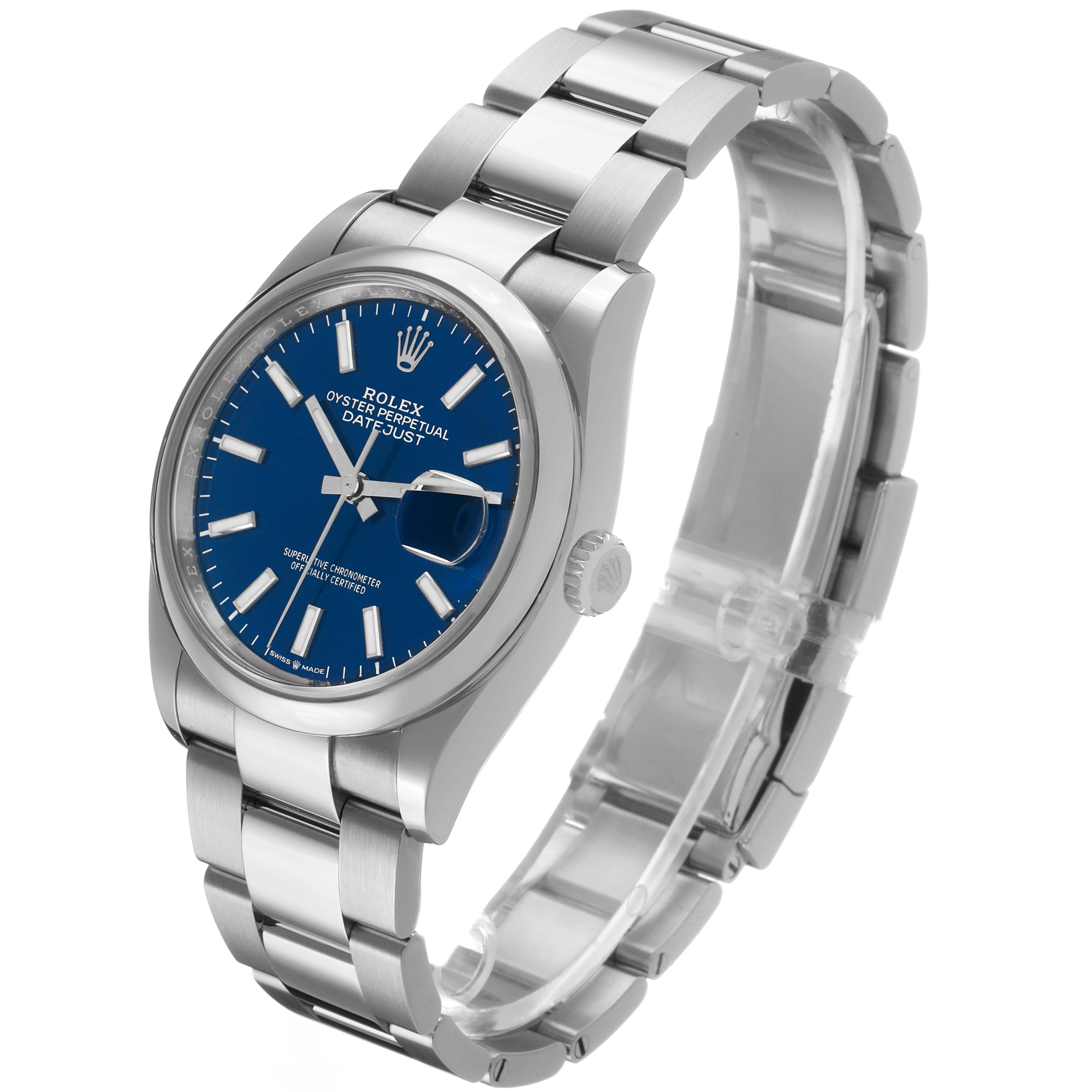 The Rolex Datejust 126200 Men's Stainless Steel Blue Dial watch is shown at a three-quarter angle, displaying the blue dial, bracelet, and crown.