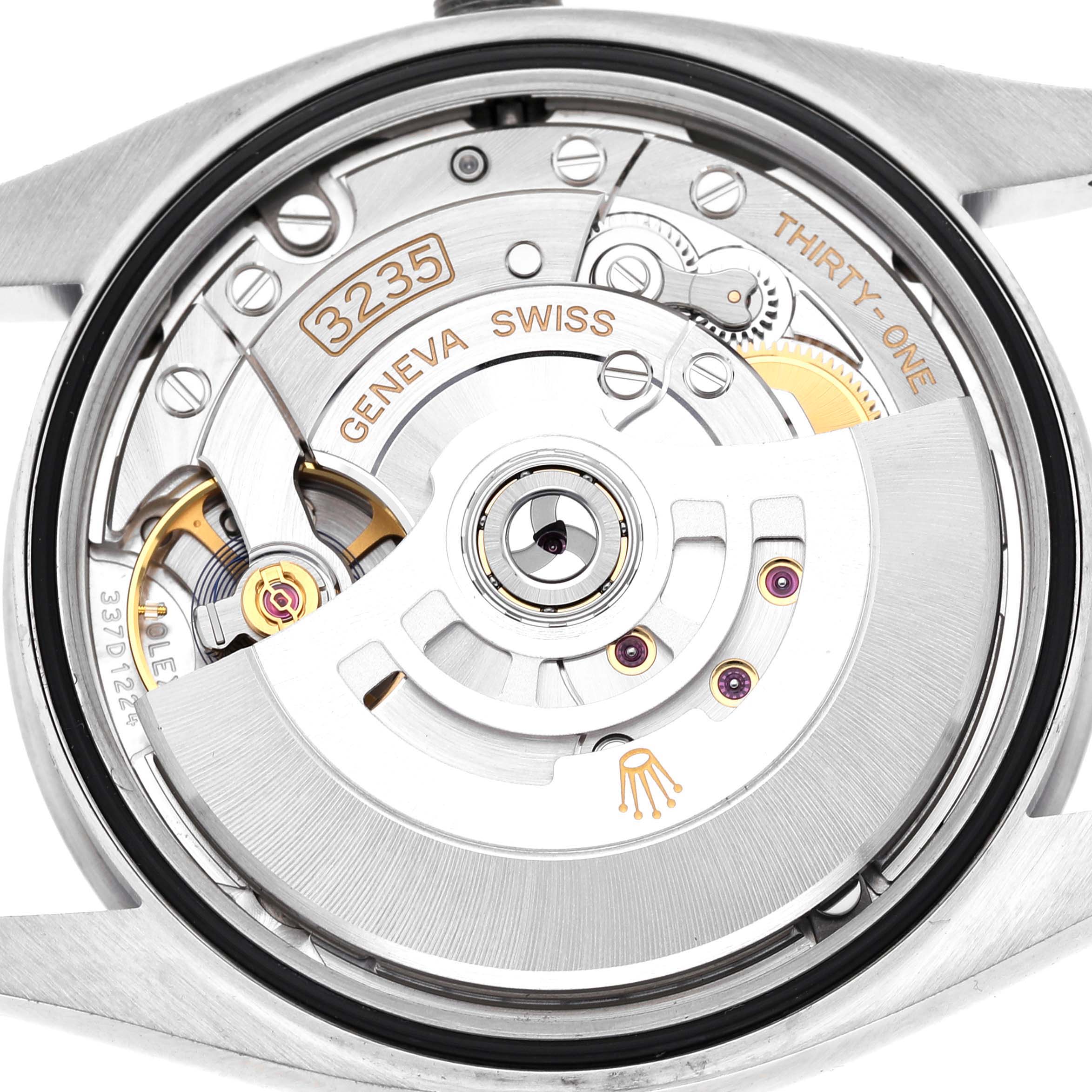 This image shows the movement of a Rolex Datejust 126200 Men's Stainless Steel Blue Dial watch from a back view, highlighting its intricate mechanical components.