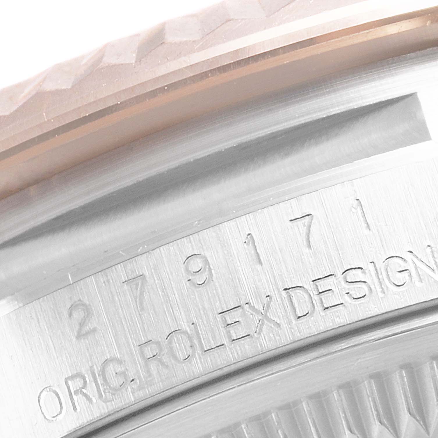 The close-up image of the Rolex Datejust 279171 Women's Steel and Gold (two tone) Blue Dial 279171 Women's Steel and Gold (two tone) Blue Dial watch shows the edge of the bezel and part of the case with engraved text.