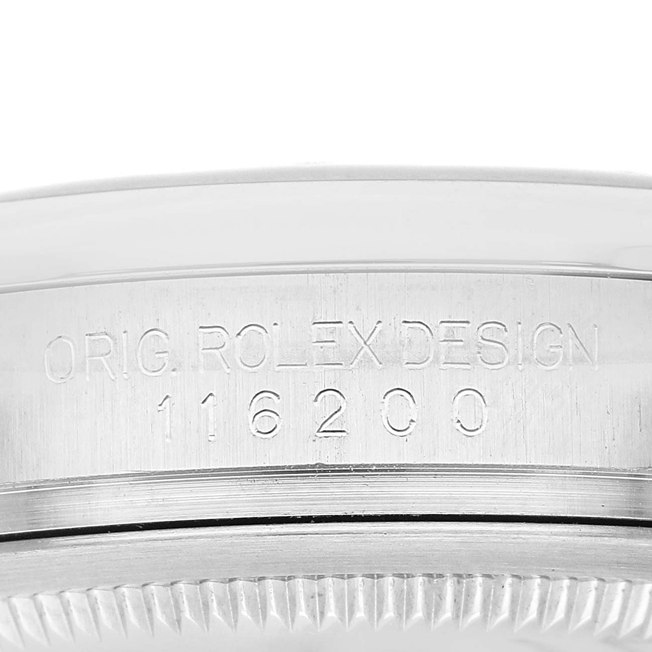 The image shows a close-up of the engraved bezel side of a Rolex Datejust 116200 Men's Stainless Steel White Dial watch.