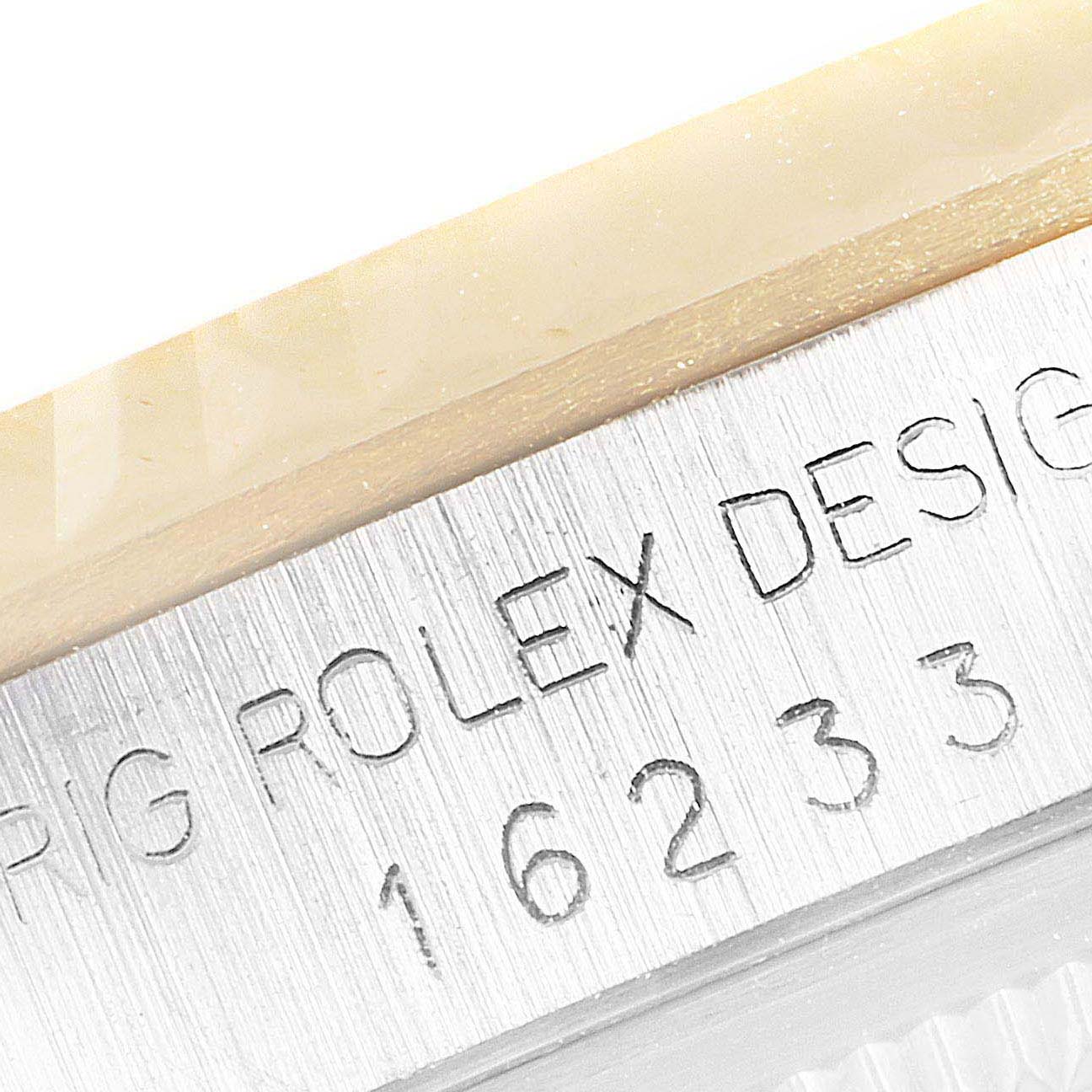 The image shows a close-up of the engraved model number and brand name on the case of a Rolex Datejust 16233 Men
s Steel and Gold (two tone) Mother of Pearl Dial 16233 Men
s Steel and Gold (two tone) Mother of Pearl Dial watch.