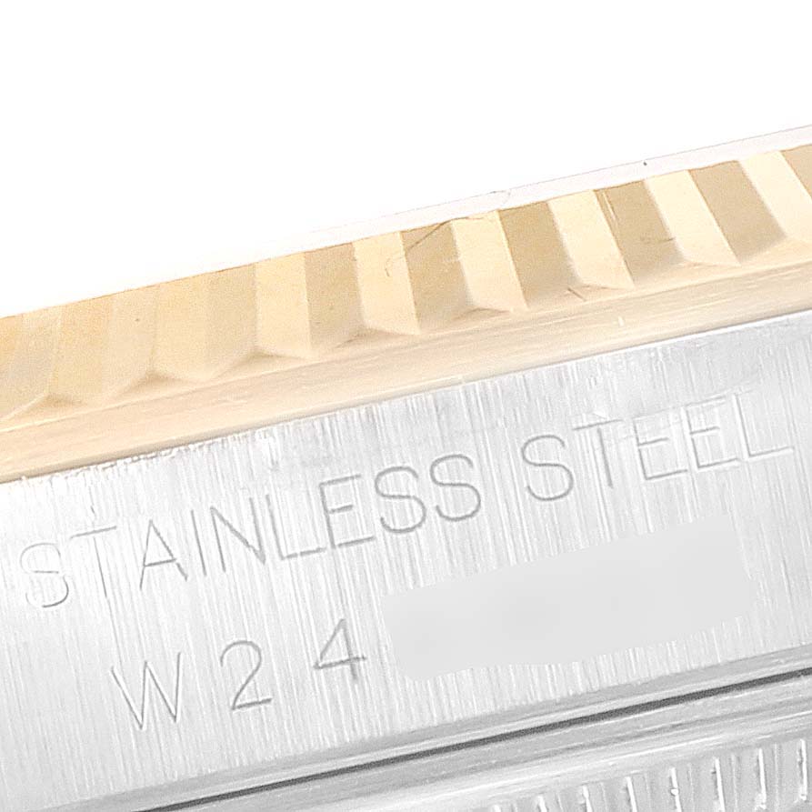 This image shows a close-up of the fluted bezel and the "Stainless Steel" engraving on a Rolex Datejust 16233 Men
s Steel and Gold (two tone) Mother of Pearl Dial 16233 Men
s Steel and Gold (two tone) Mother of Pearl Dial watch.