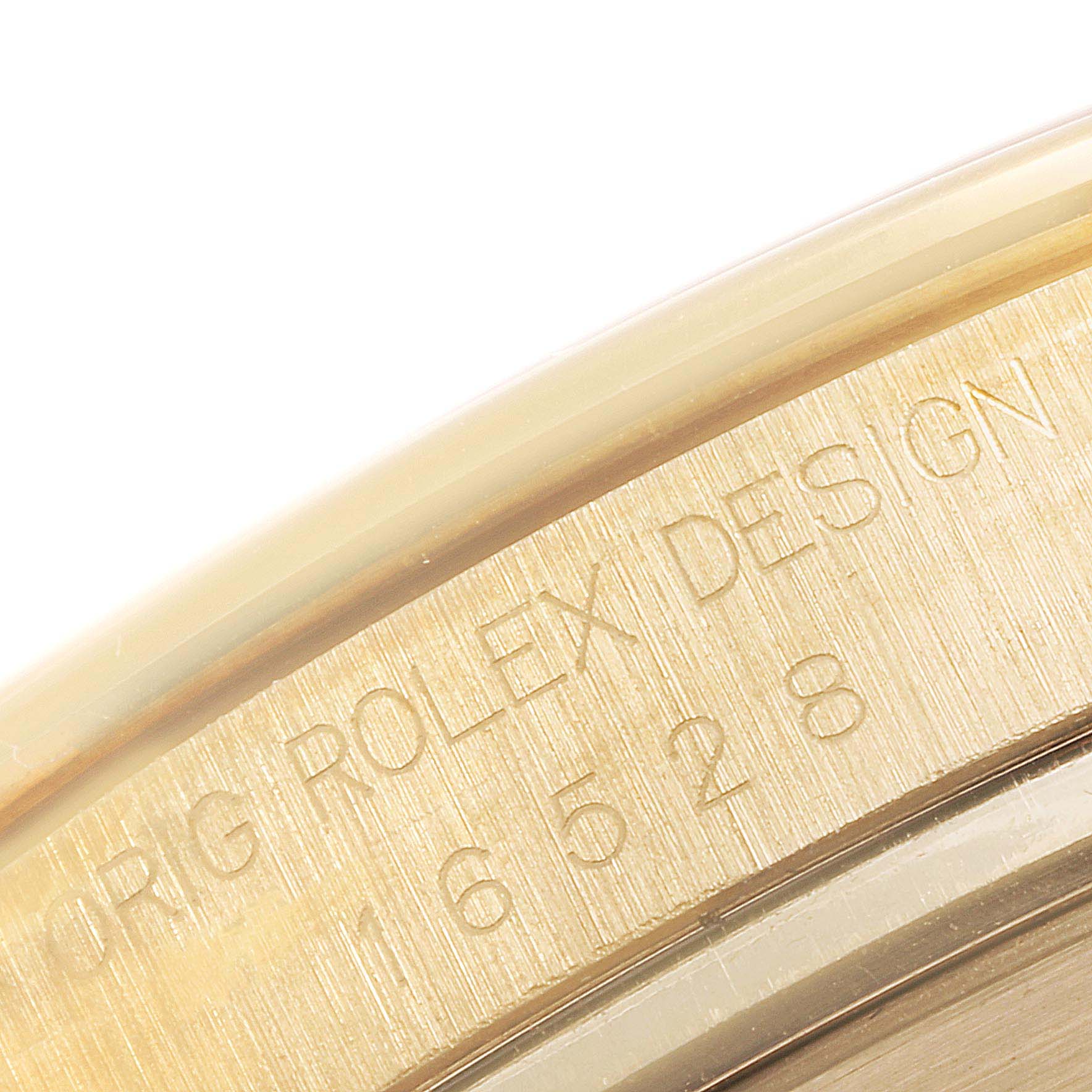 This image shows a close-up of the case side of the Rolex Daytona 16528 Men's Yellow Gold Black Dial 16528 Men's Yellow Gold Black Dial watch, featuring the engraved model number.