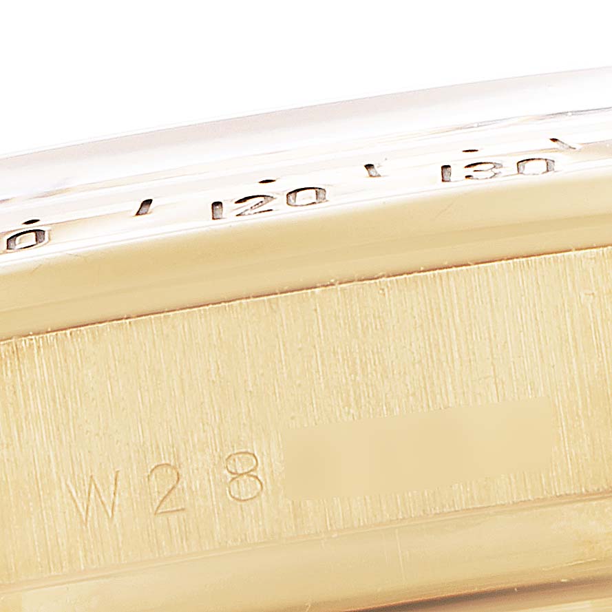 This image shows a close-up side angle of the Rolex Daytona 16528 Men's Yellow Gold Black Dial 16528 Men's Yellow Gold Black Dial watch, highlighting the bezel and part of the case.